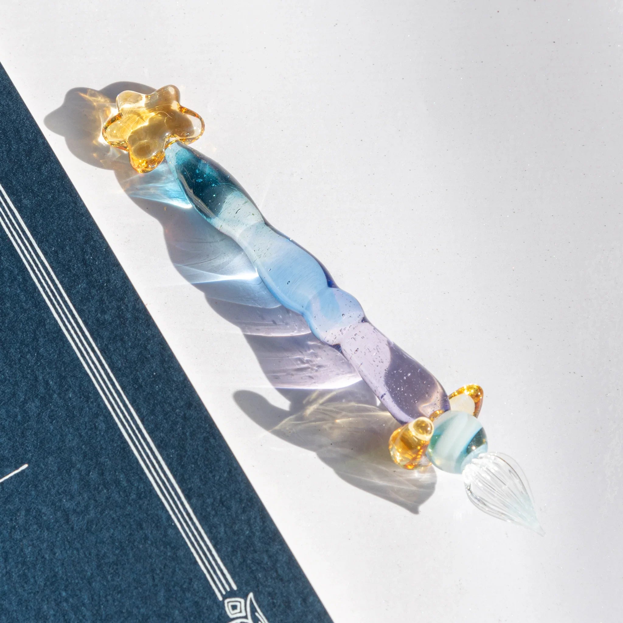 Starlit Night glass dip pen with deep blue to purple gradient barrel and distinctive gold star-shaped pen rest