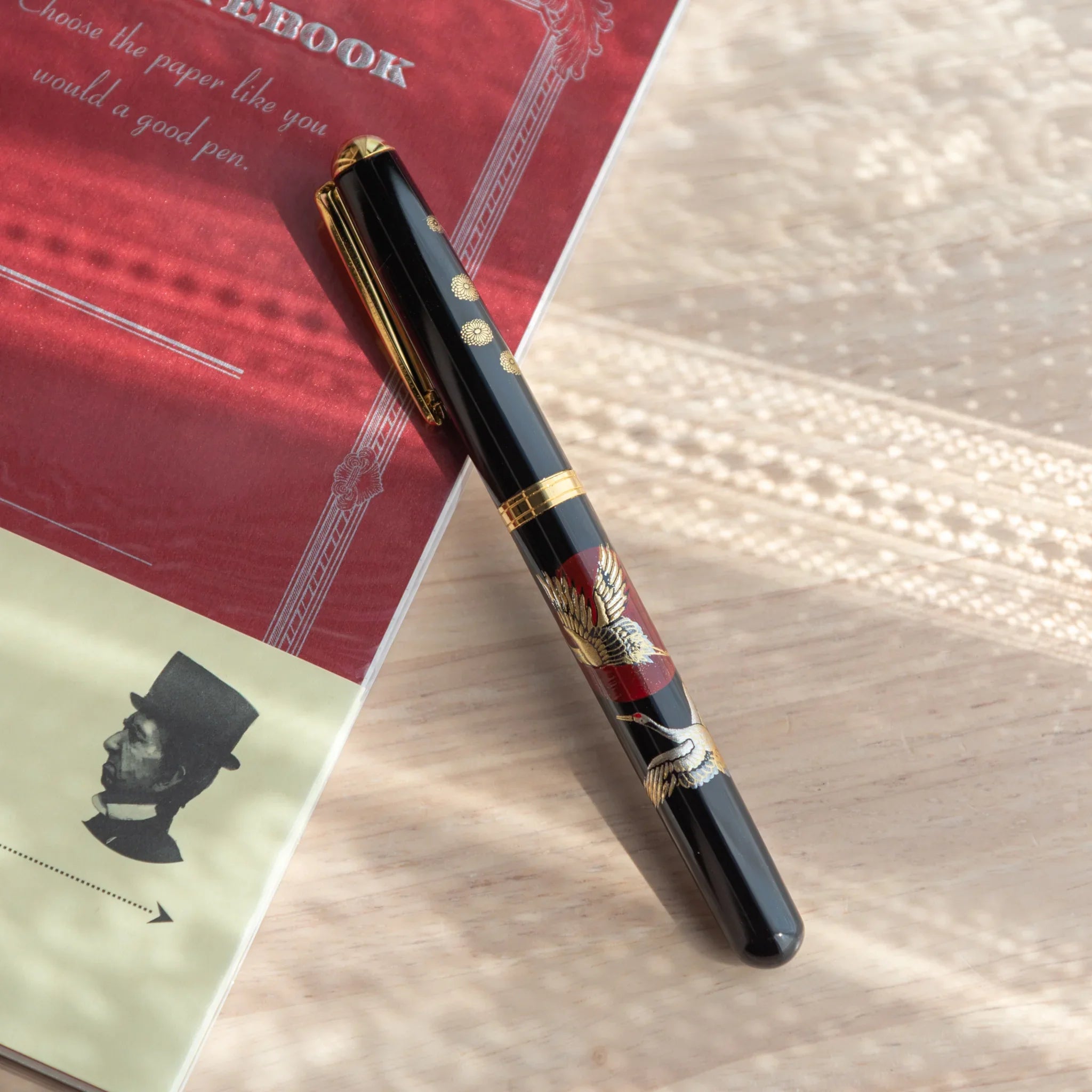 Sunrise Cranes Yamanaka fountain pen displays hand-painted lacquer crane and sunrise motif art for writing
