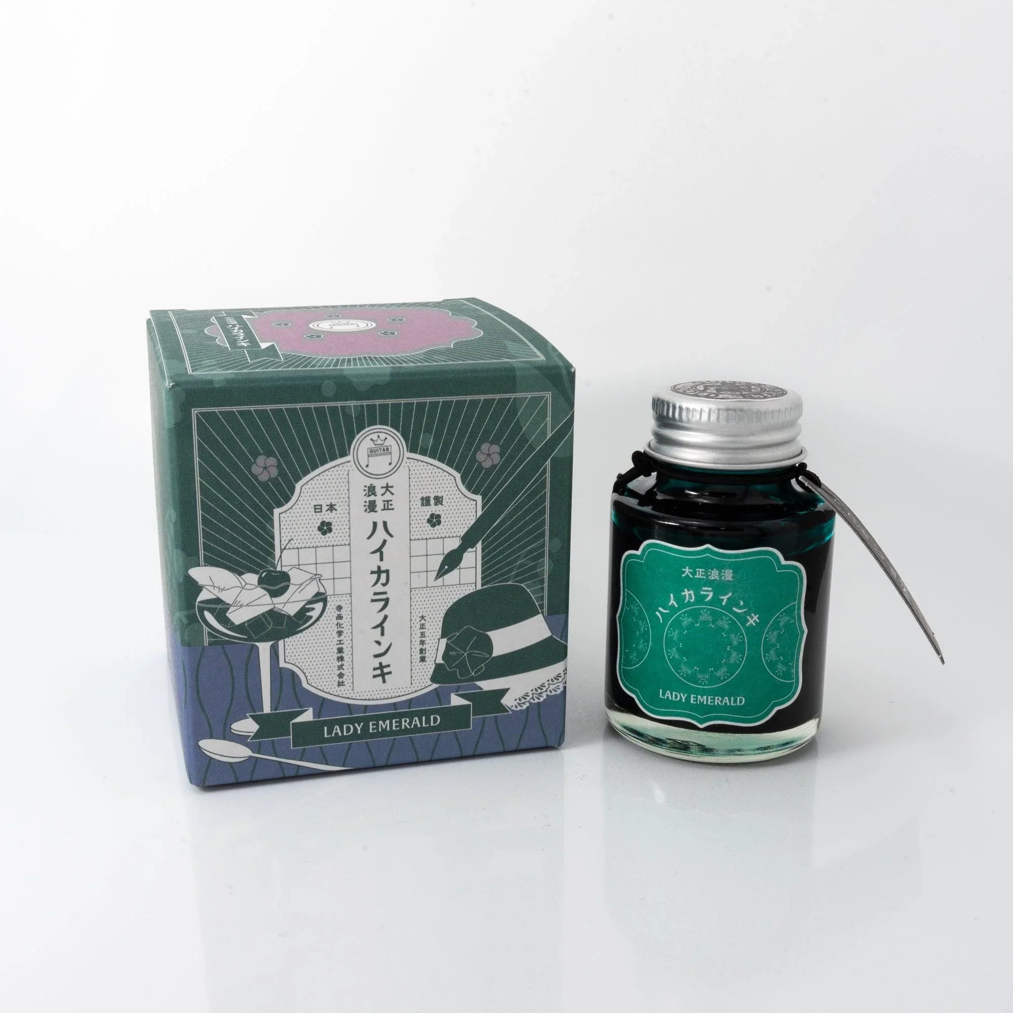 Taisho Romance Lady Emerald fountain pen ink bottle and black box with emerald green accents displayed