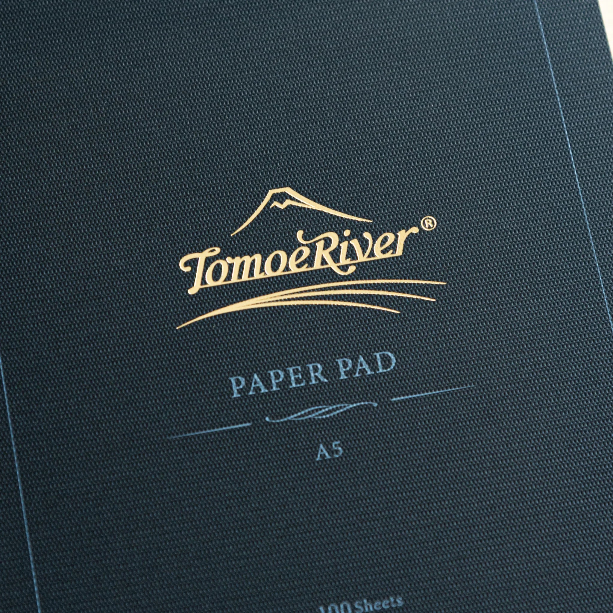 Sanzen Tomoe River FP pad spine showing Japanese text and product information on dark background for fountain pen writing