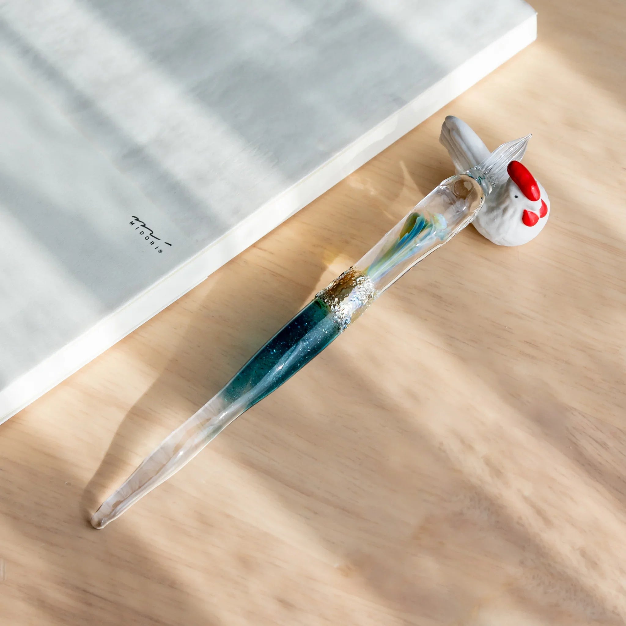 Deep blue Tsukuyomi glass dip pen photographed to showcase twisted nib detail with moon goddess inspiration shine
