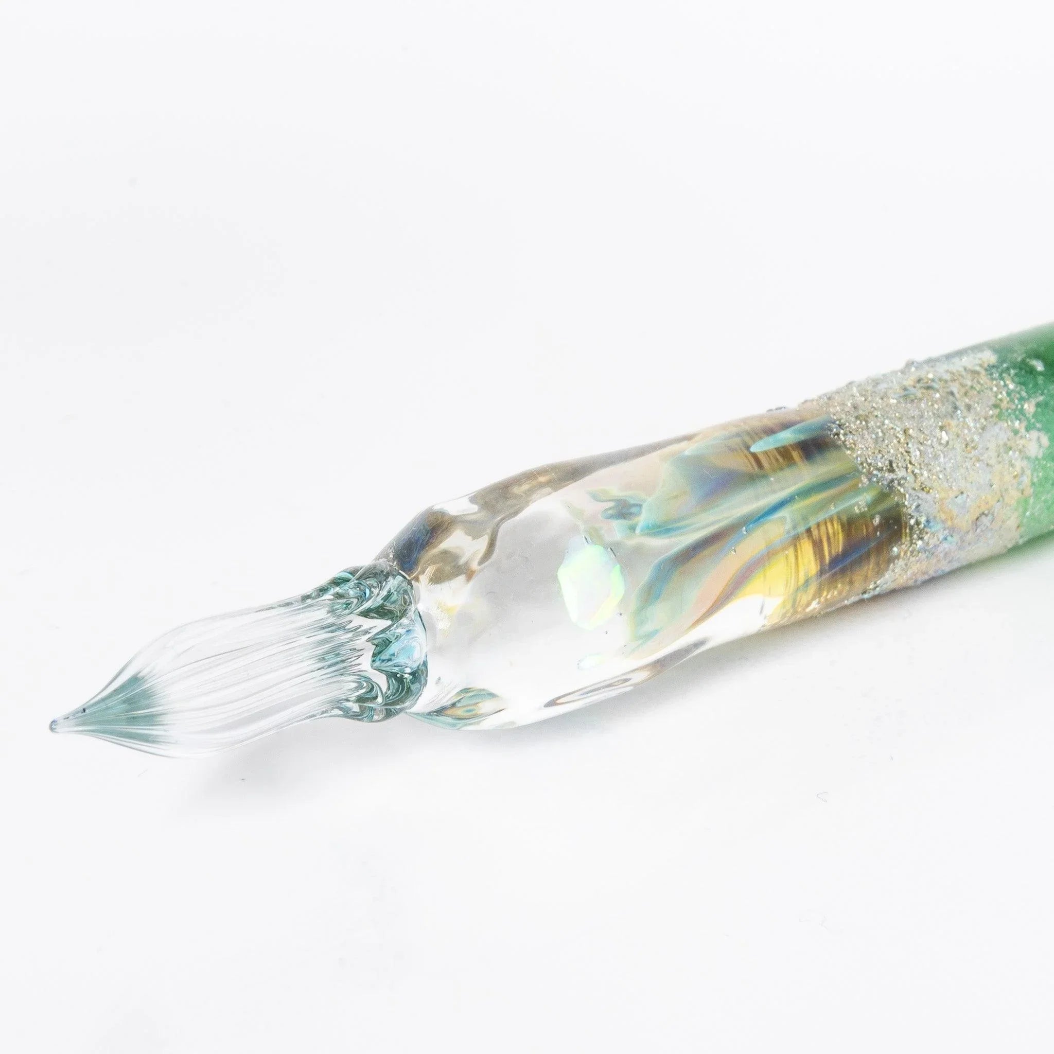 Close-up view of Tsukuyomi green glass dip pen nib tip showing detailed metal work and pointed writing edge shine