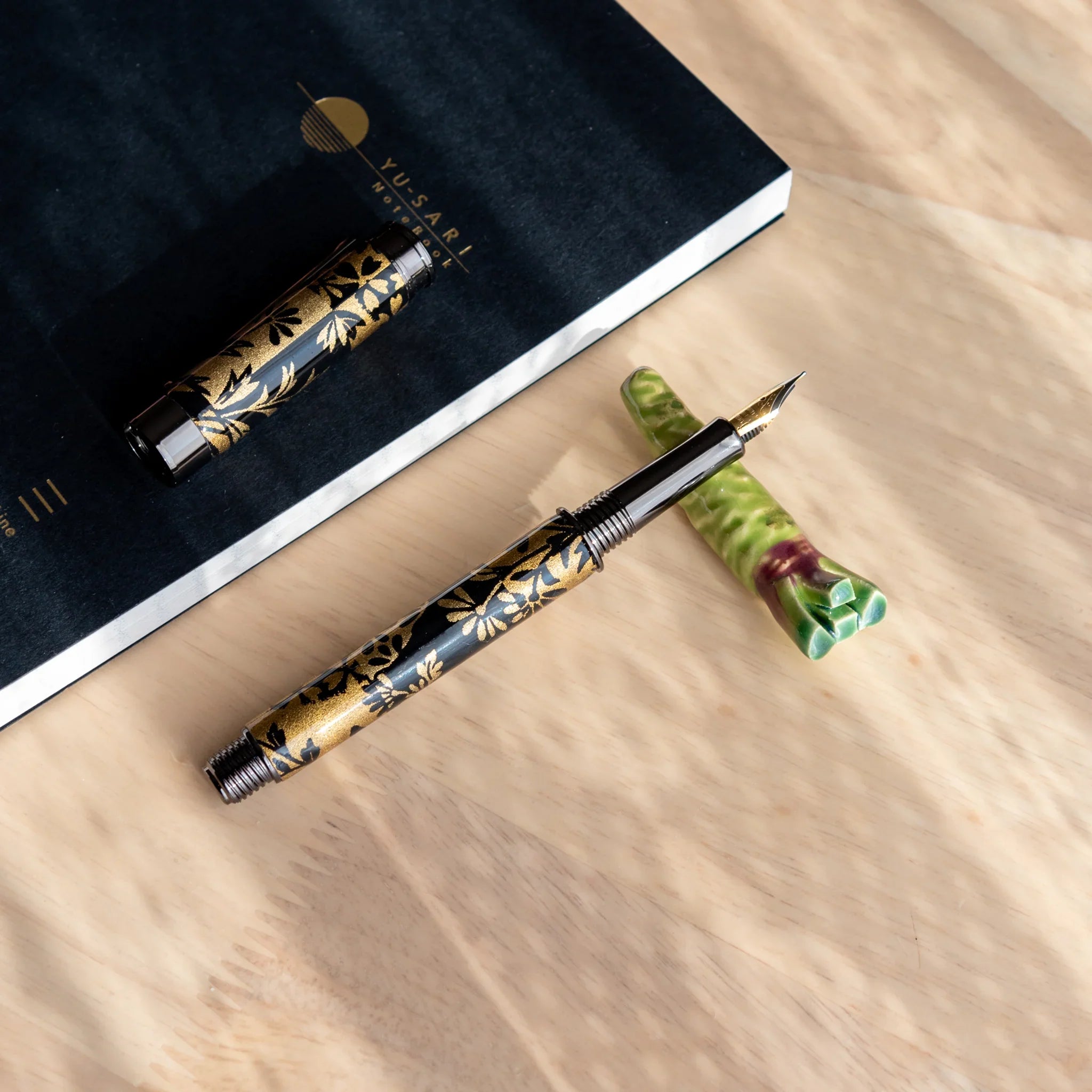 Vivid green wasabi handcrafted pen rest showing detailed texture with functional grooved holder overall on neutral surface