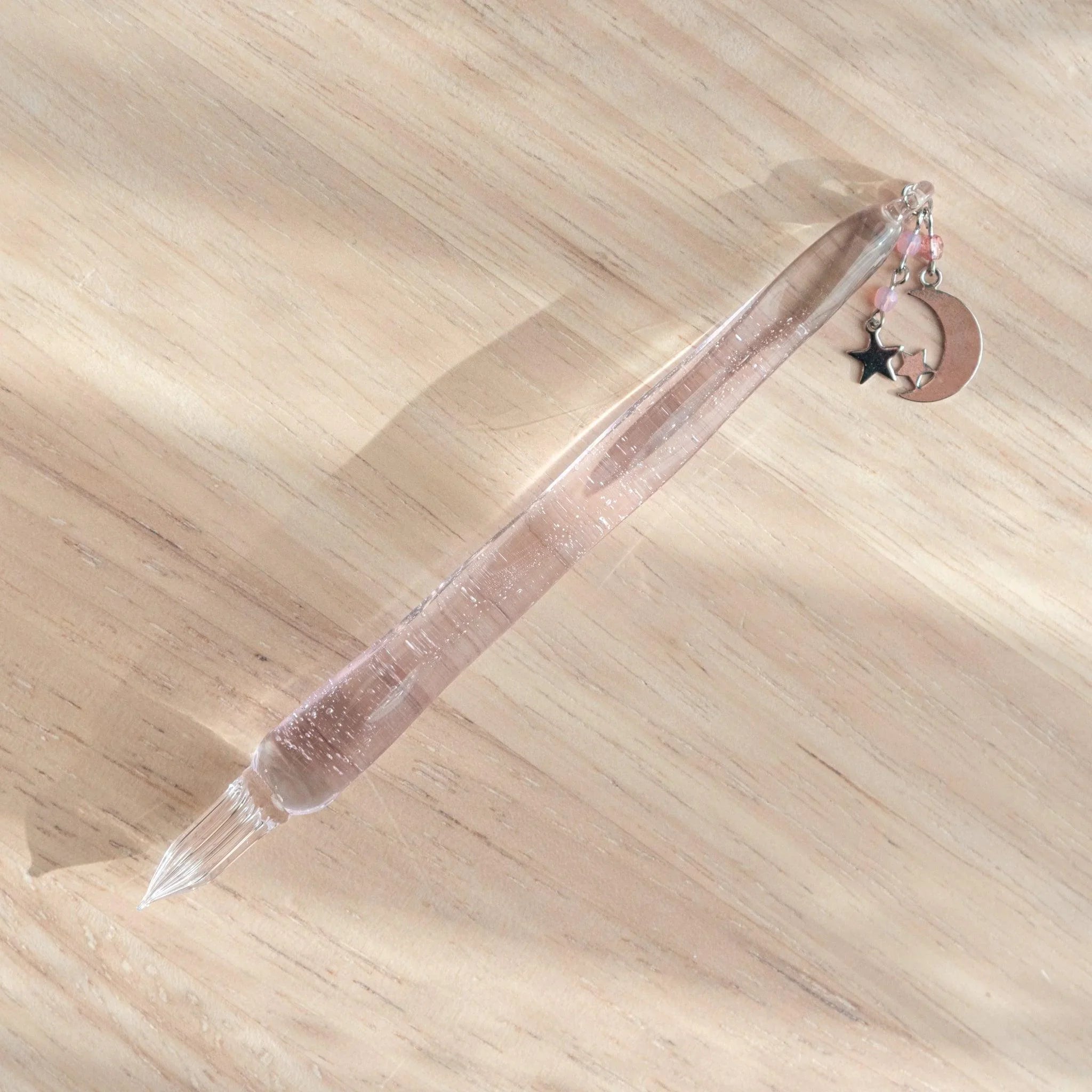 Pink glass dip pen with wish upon a star pattern featuring celestial design and stellar motif decoration style