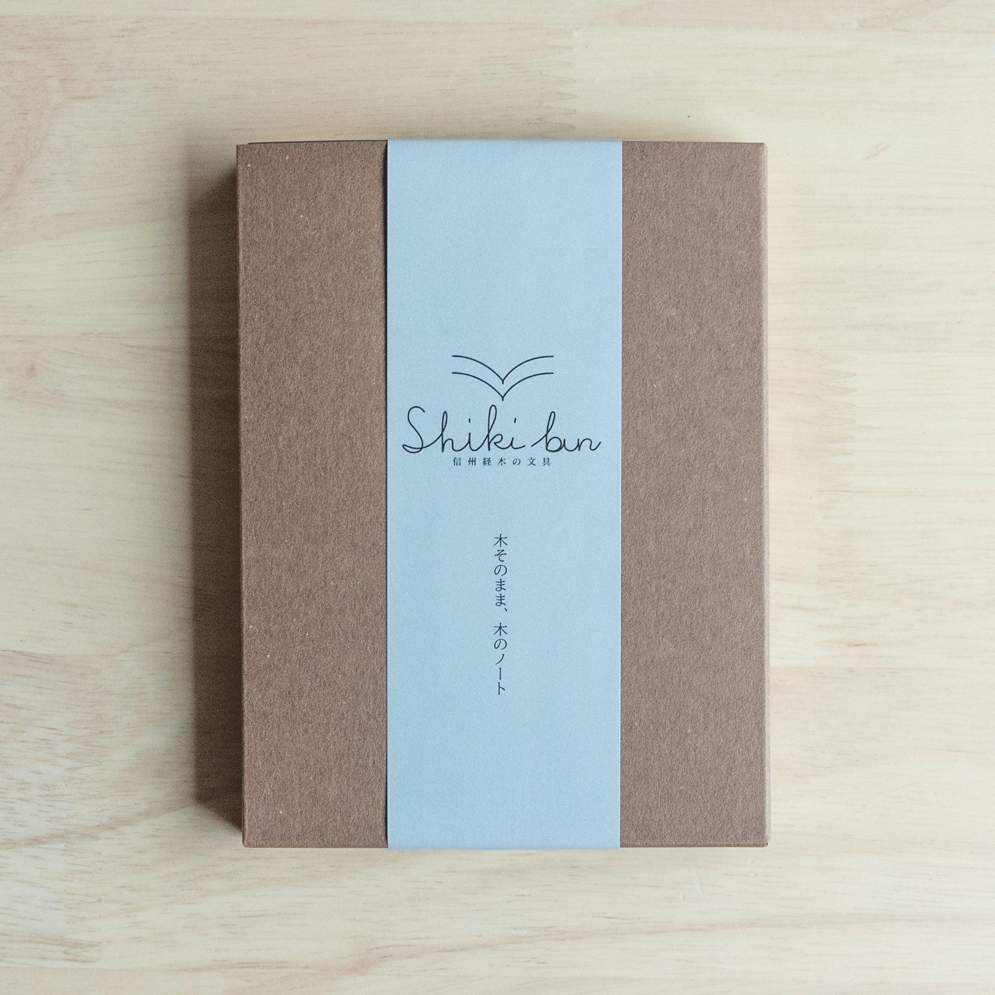 Natural red pine wooden page A6 notebook, angled shot of wood grain detail and binding construction showing natural wood