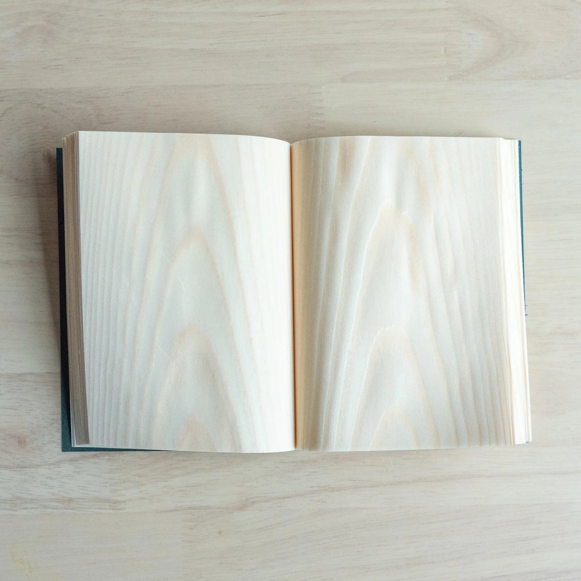 Red Pine wood-paged A6 journal, back view with wooden page construction detail and binding craft showing natural wood