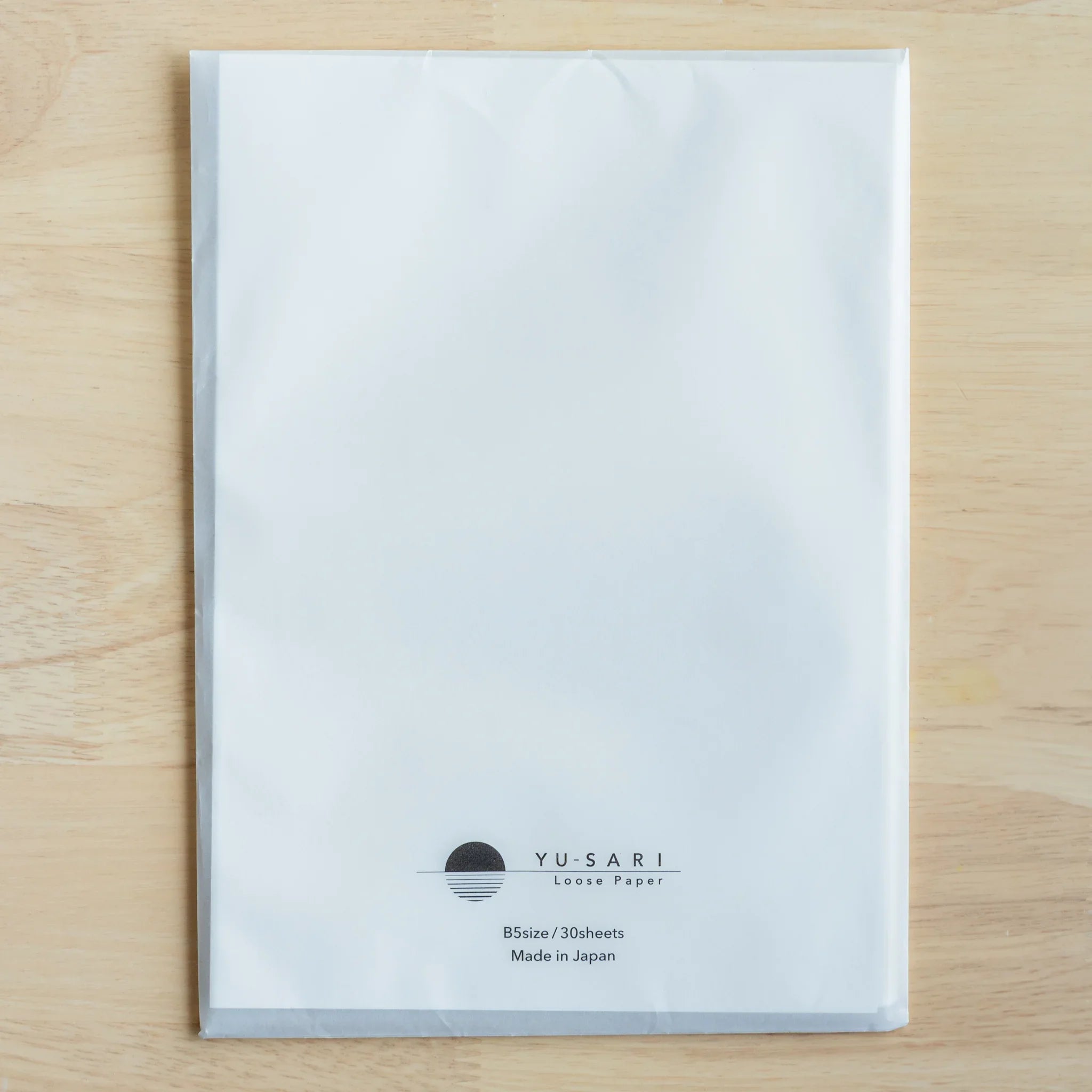 YU-SARI loose leaf paper white sheets close-up detail Japanese branded labeling showing made in Japan on packaging trim