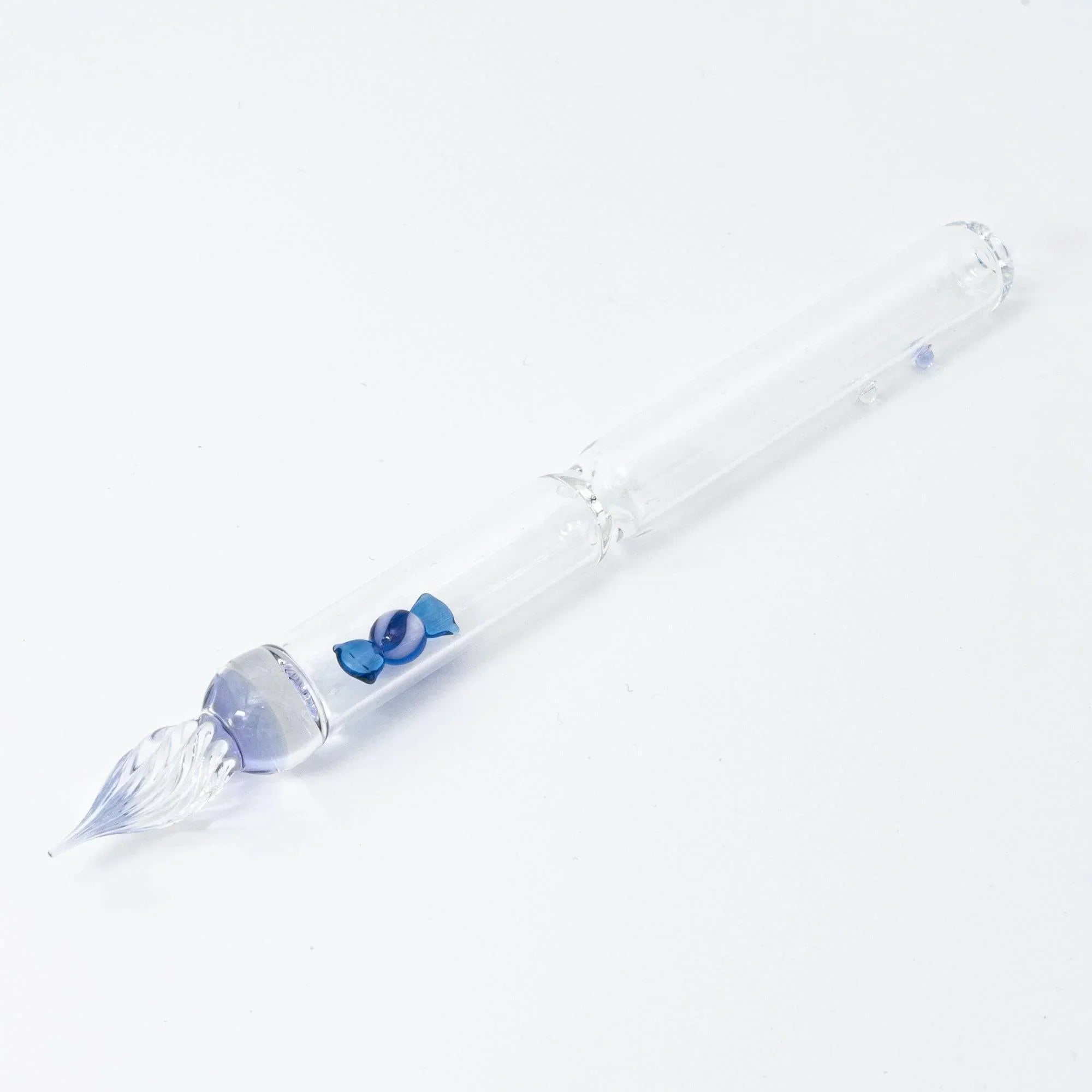 Japanese hand-blown blue glass dip pen with trapped candy bubble inclusions throughout the glass shaft and handle
