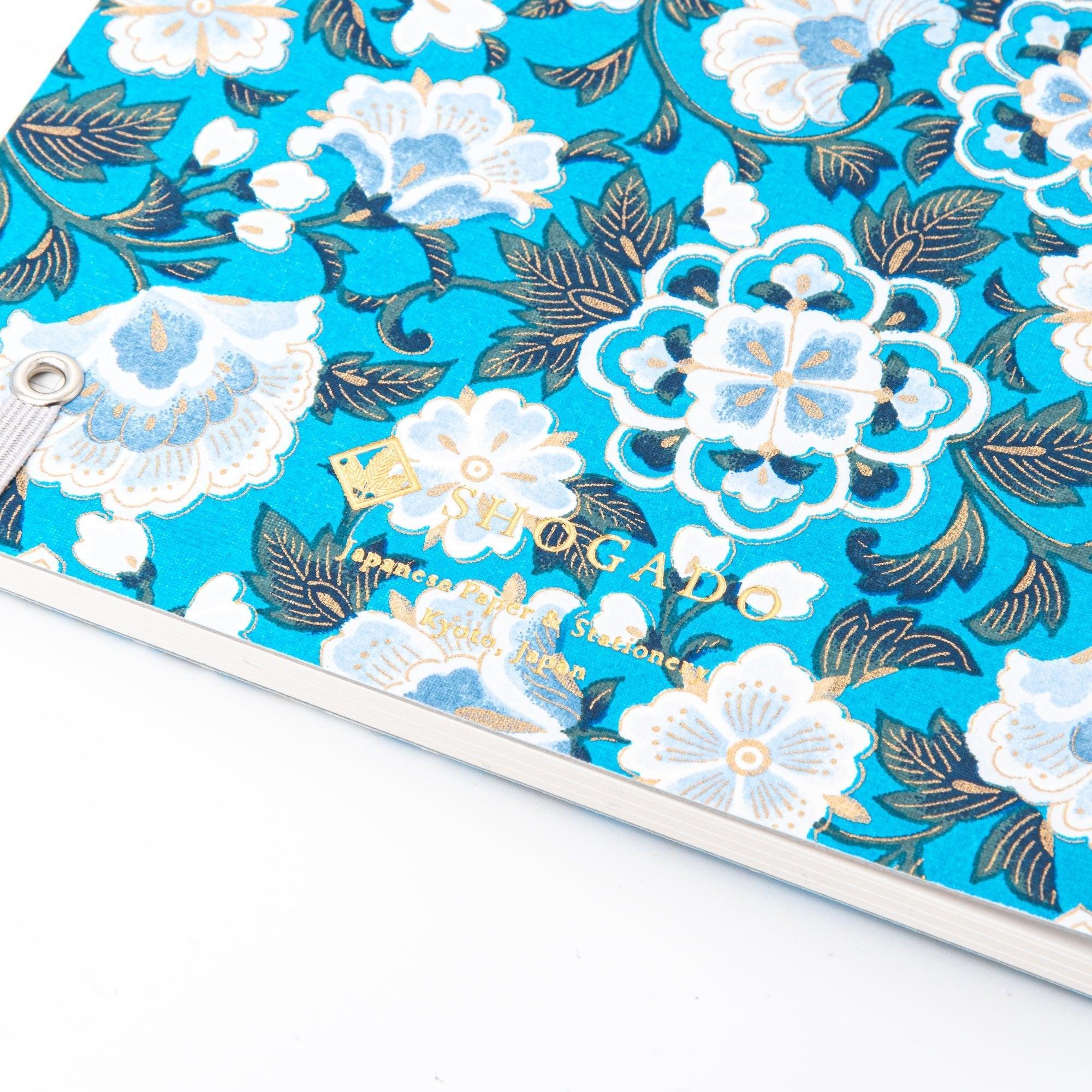 Spiral notebook with blue garden washi design showing cover front and some inner blank pages for writing