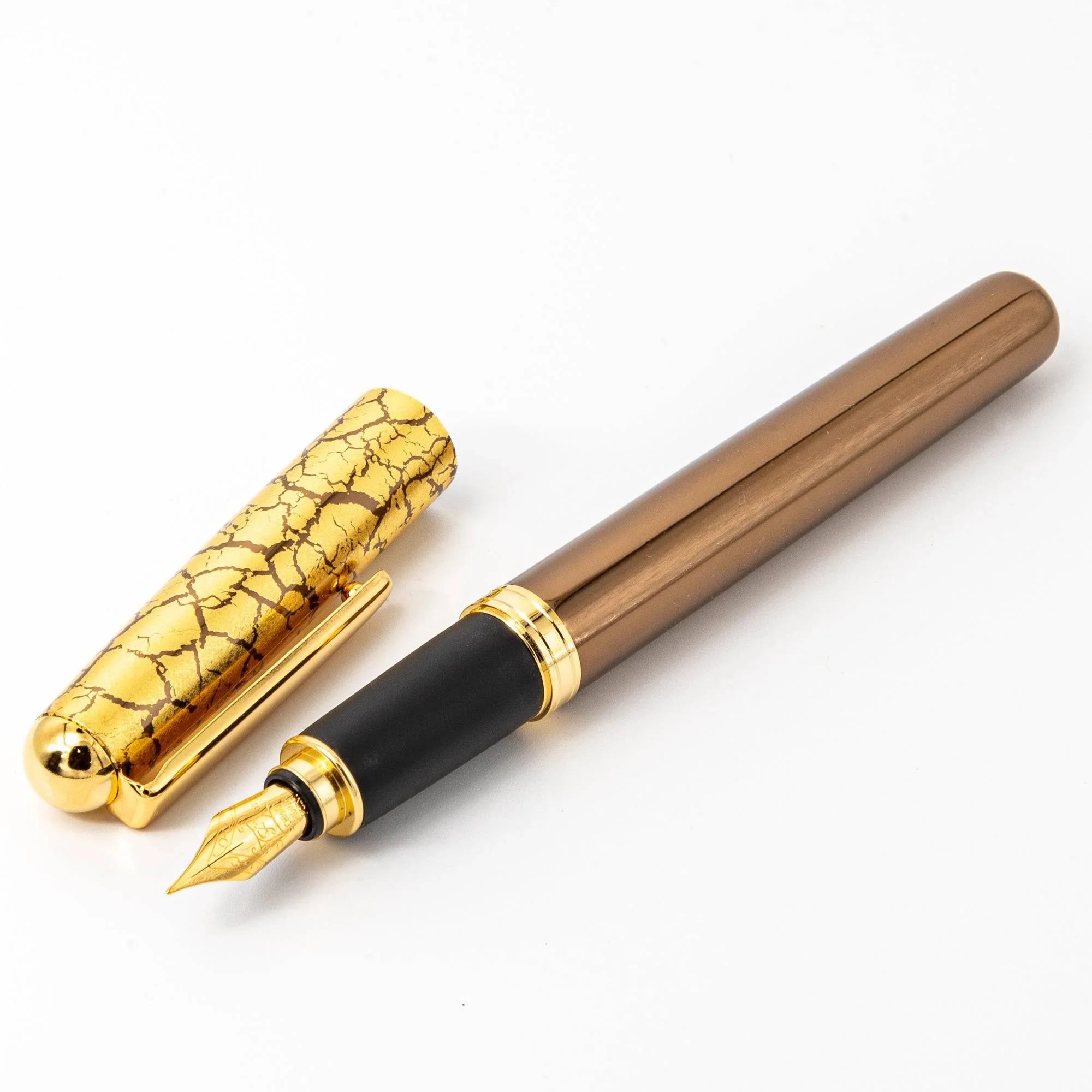 Brown lacquer Japanese fountain pen with capped design showing fine gold crackle pattern on barrel detail