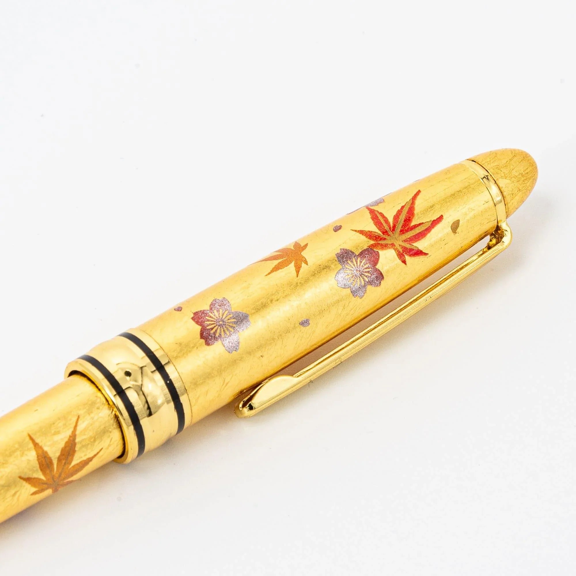 Side view Gold Leaf Sakura and Momiji Makie ballpoint pen showing traditional seasonal floral composition
