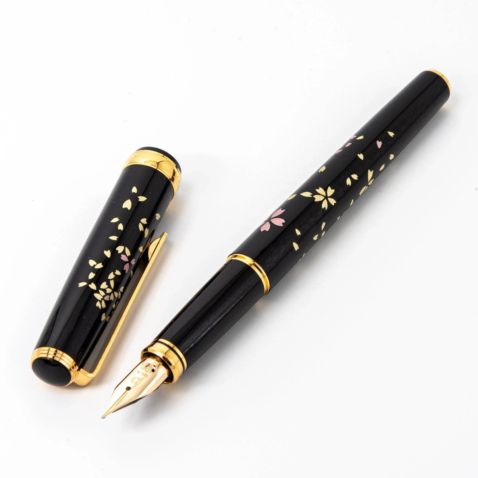 Capped and uncapped sakura fountain pen with pink gold cherry blossom Makie design, Japanese lacquer