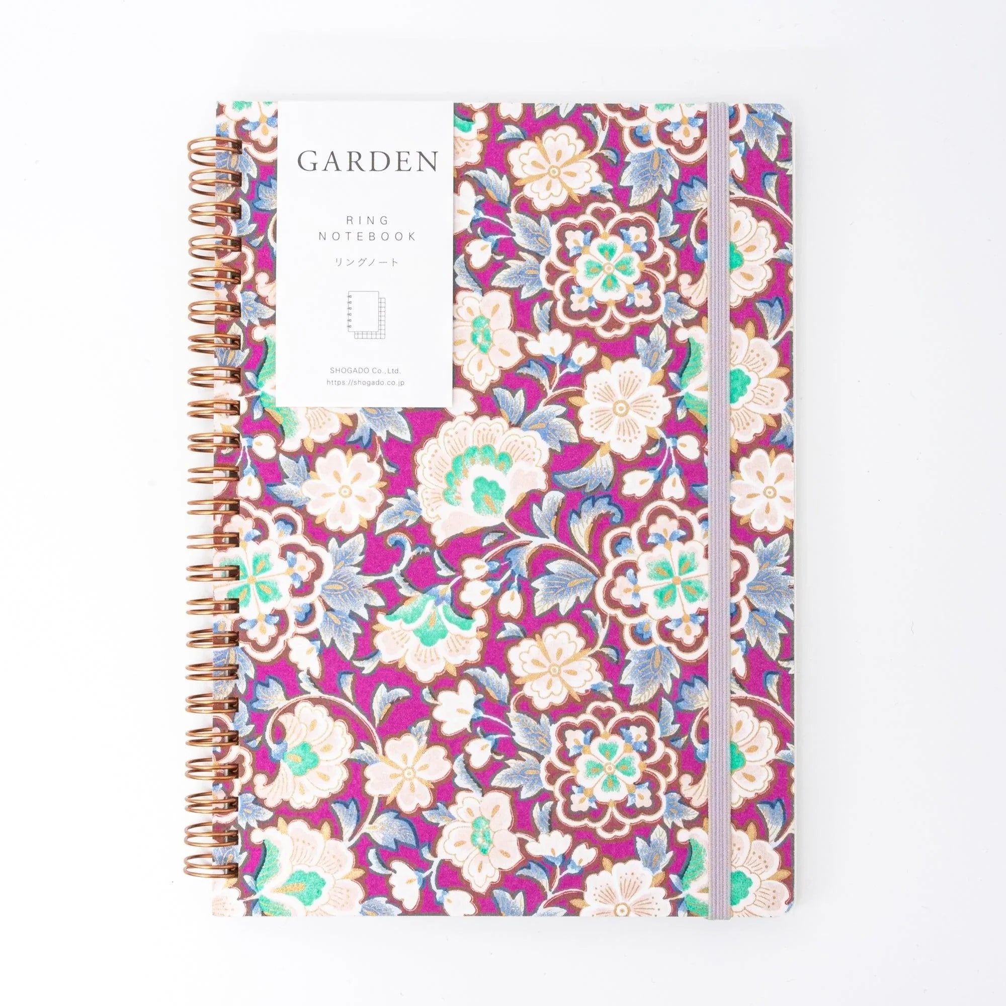 Magenta Garden Japanese ring notebook with belly band, rose gold spiral binding, and lavender elastic on white background