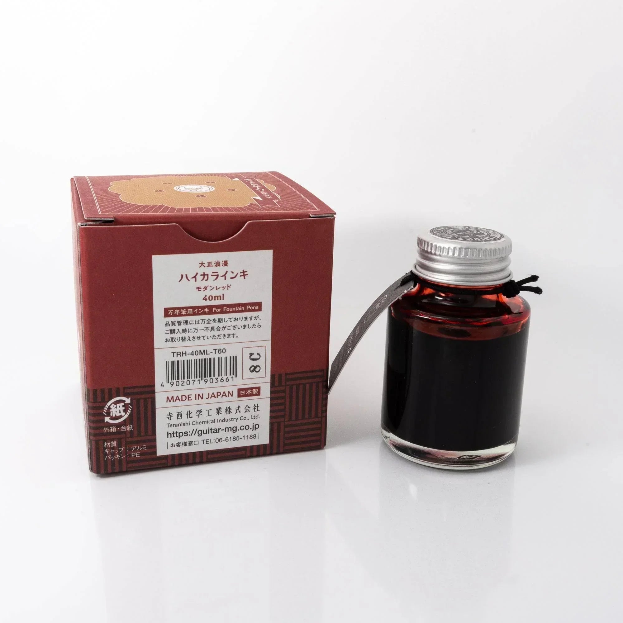Taisho Romance Modern Red ink bottle with complementary Japanese writing tools arranged on styled flatlay detail