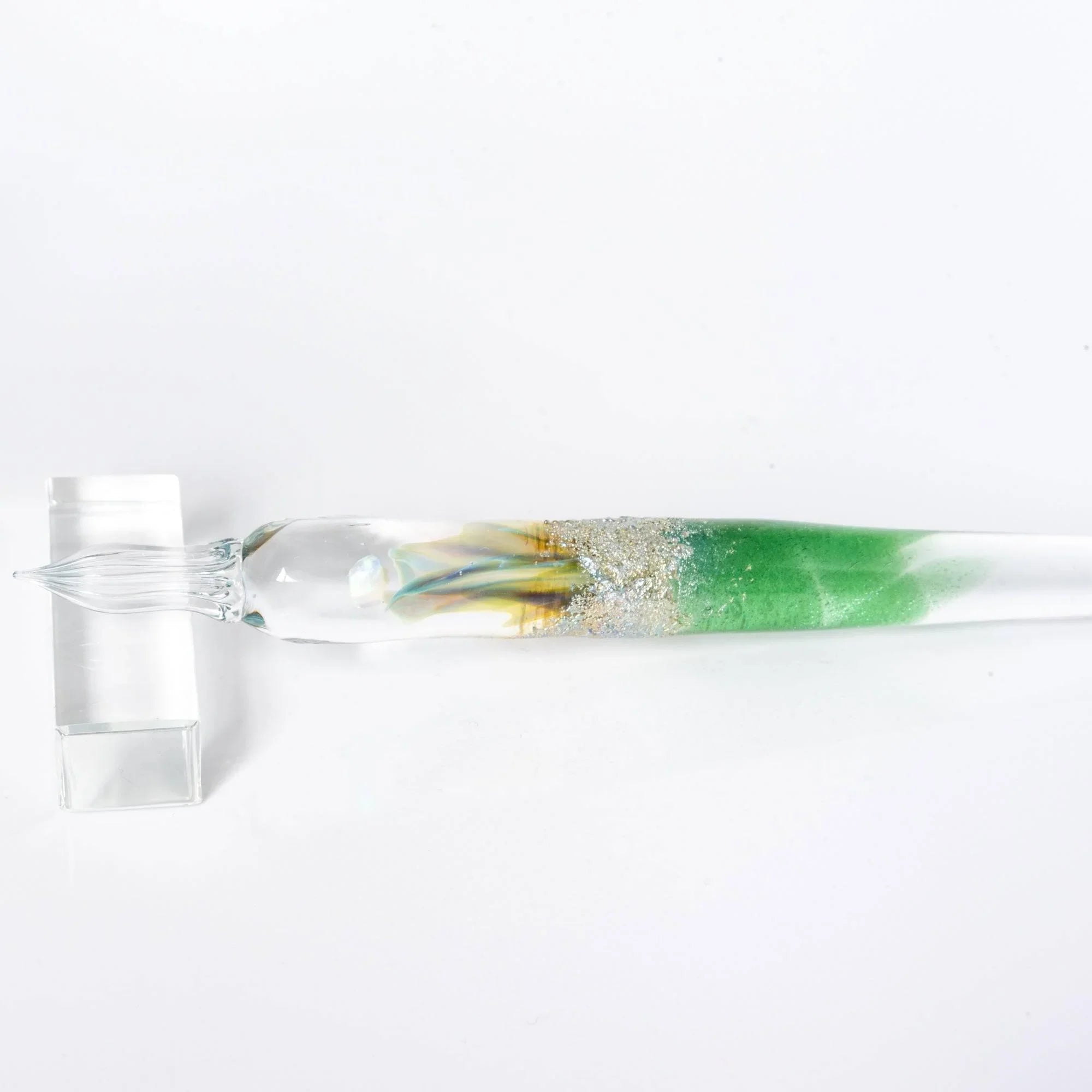 Angled view of Tsukuyomi green glass dip pen showing full length from tip to handle with gradient coloring shine