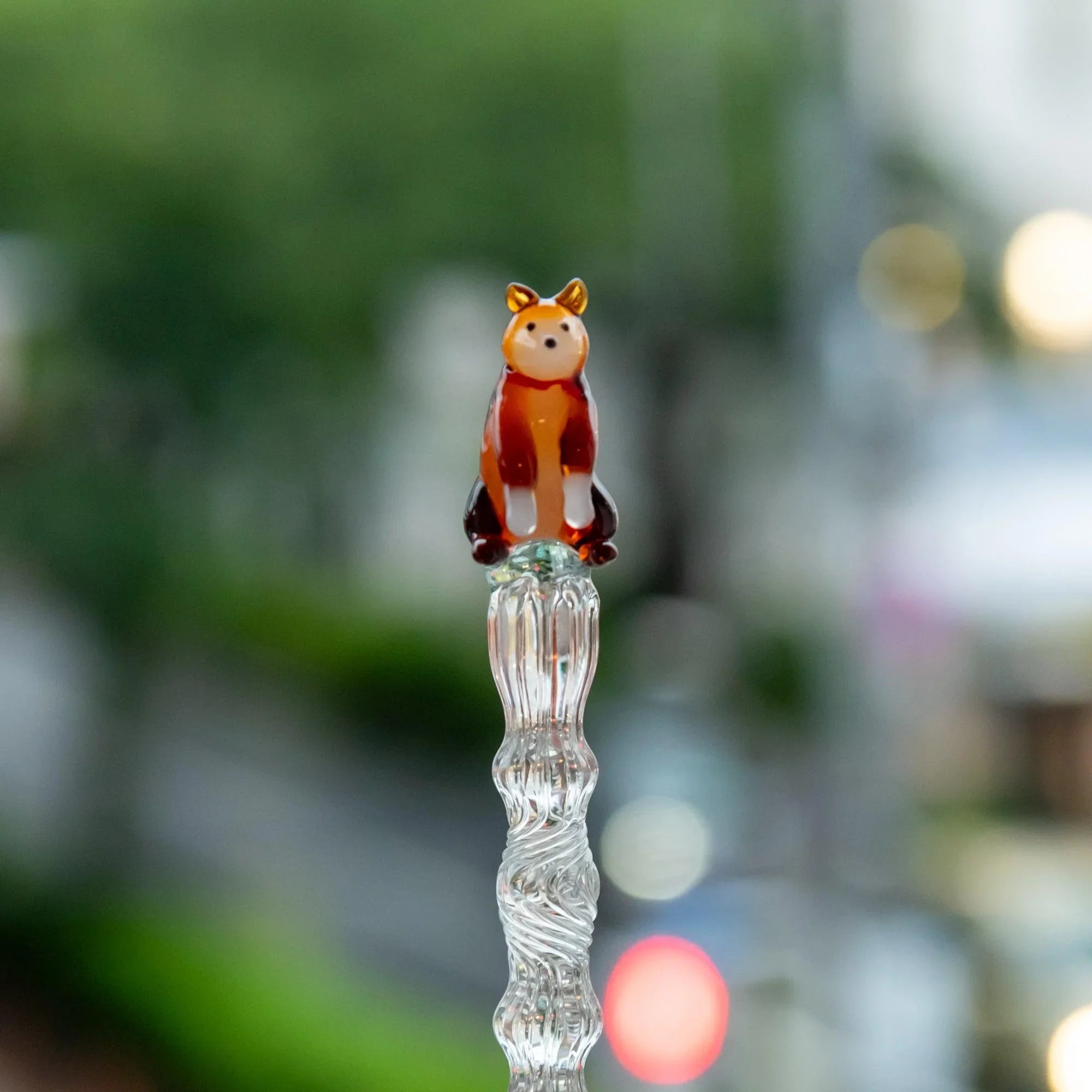 Japanese glass dip pen with ceramic reddish-brown Shiba Inu dog topper on ribbed barrel, three-quarter angle view