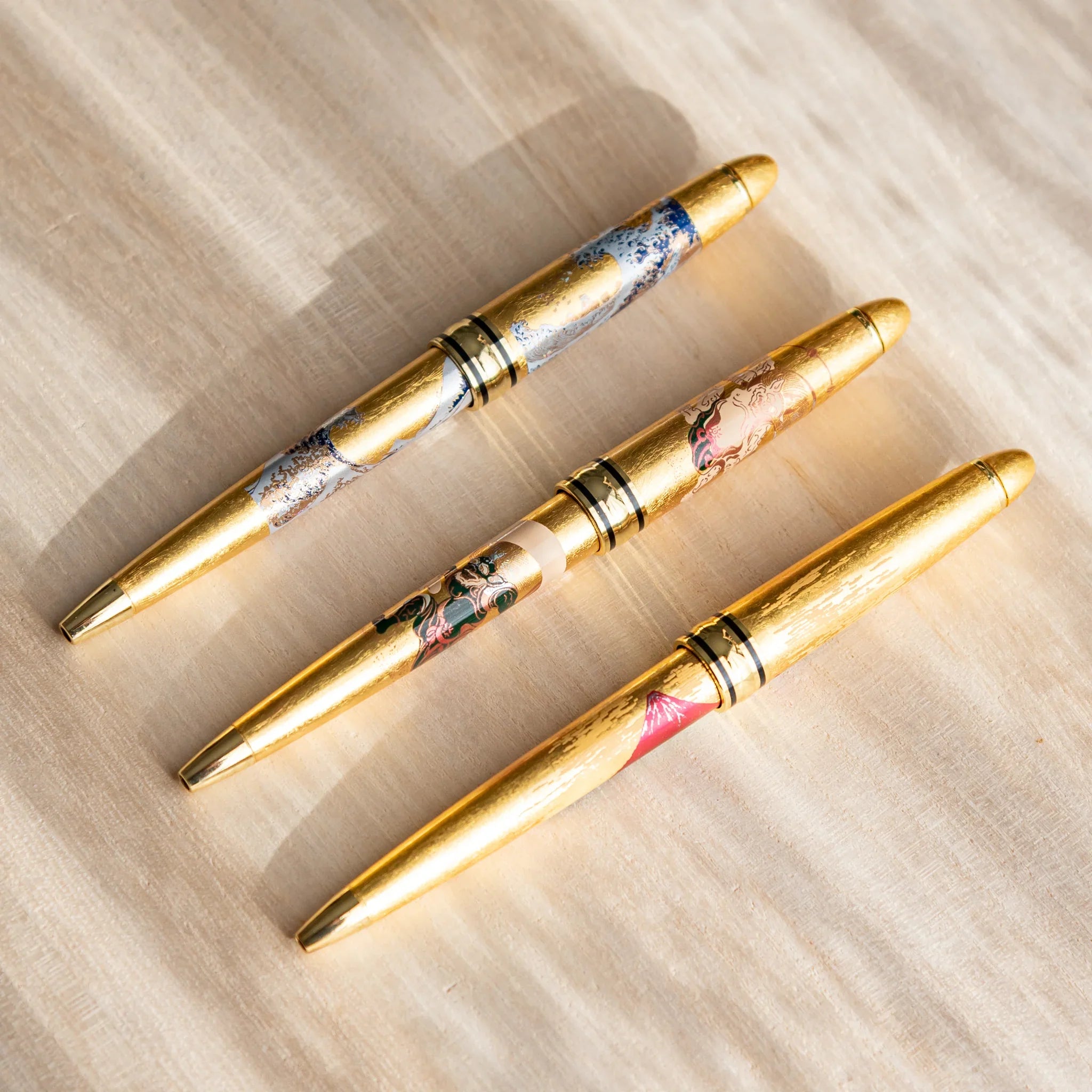 Gold Leaf decorated pen showing traditional deity artwork in detail view displayed clearly composition