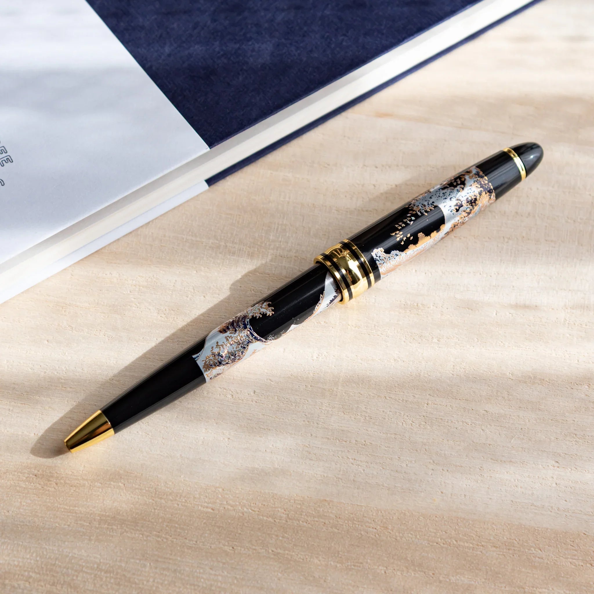 Great Wave Hokusai Yamanaka retractable ballpoint pen with black barrel design displayed clearly composition