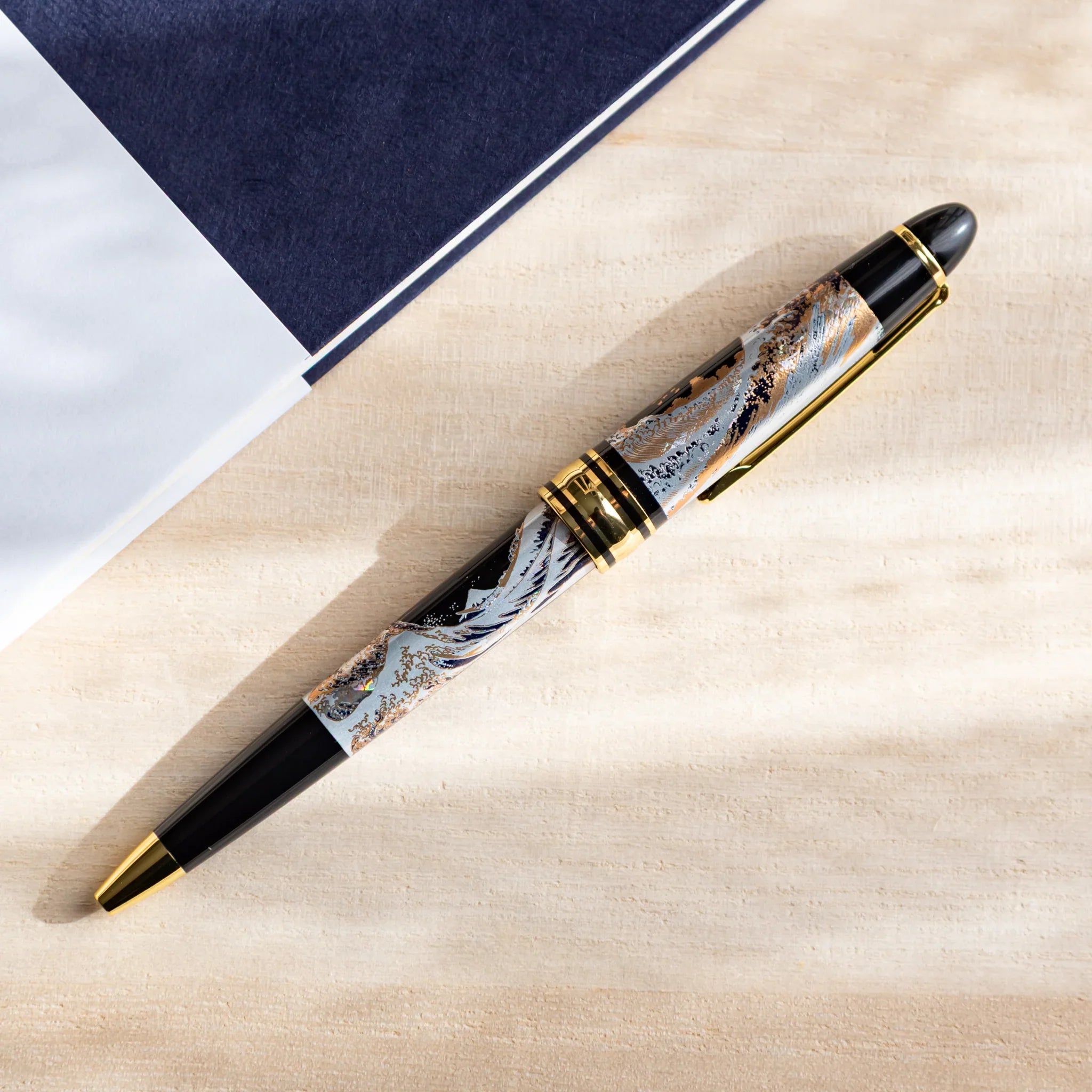 Ballpoint pen featuring Great Wave landscape with maki-e lacquer decoration displayed clearly composition