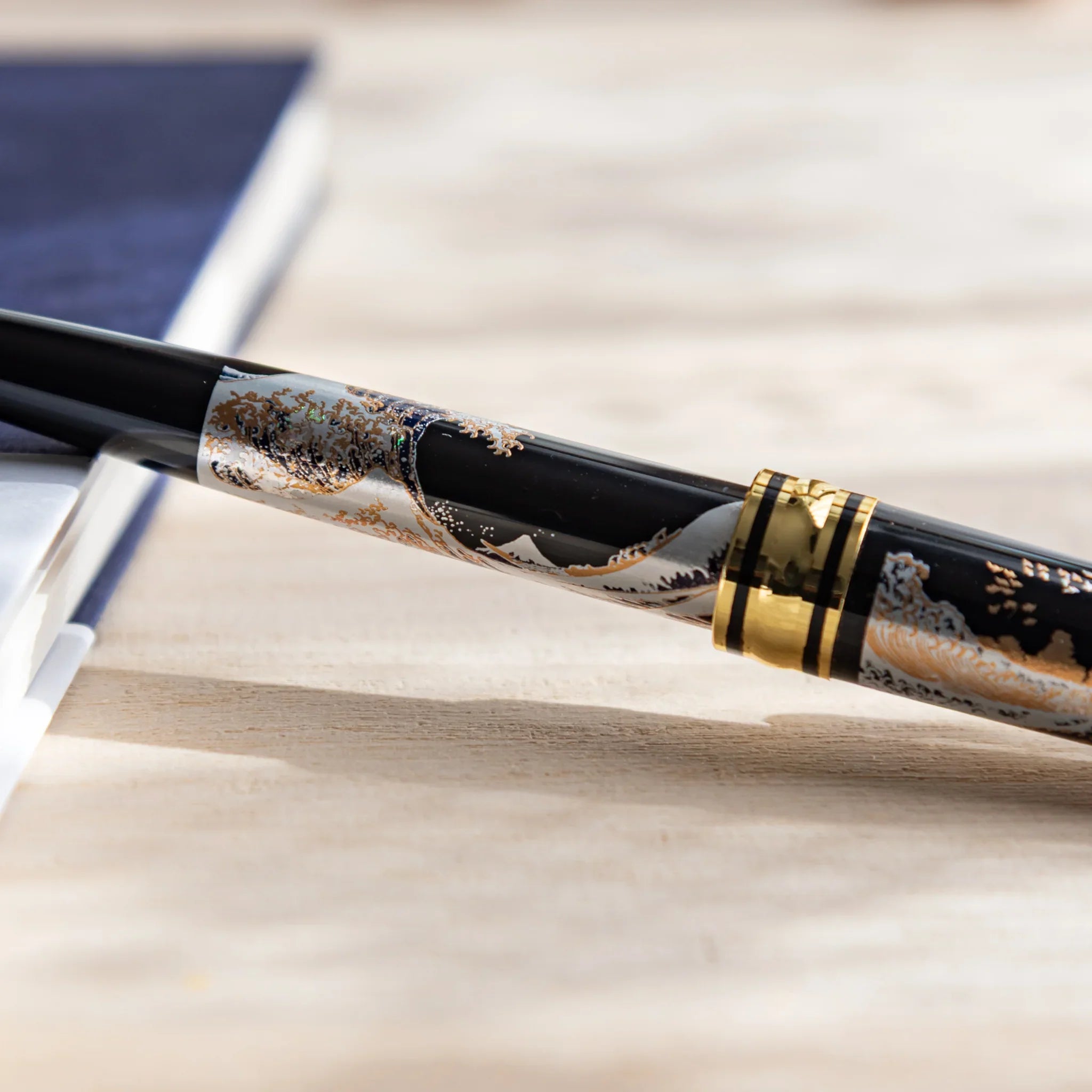 Yamanaka Great Wave pen in professional product display composition displayed clearly with gold trim accents