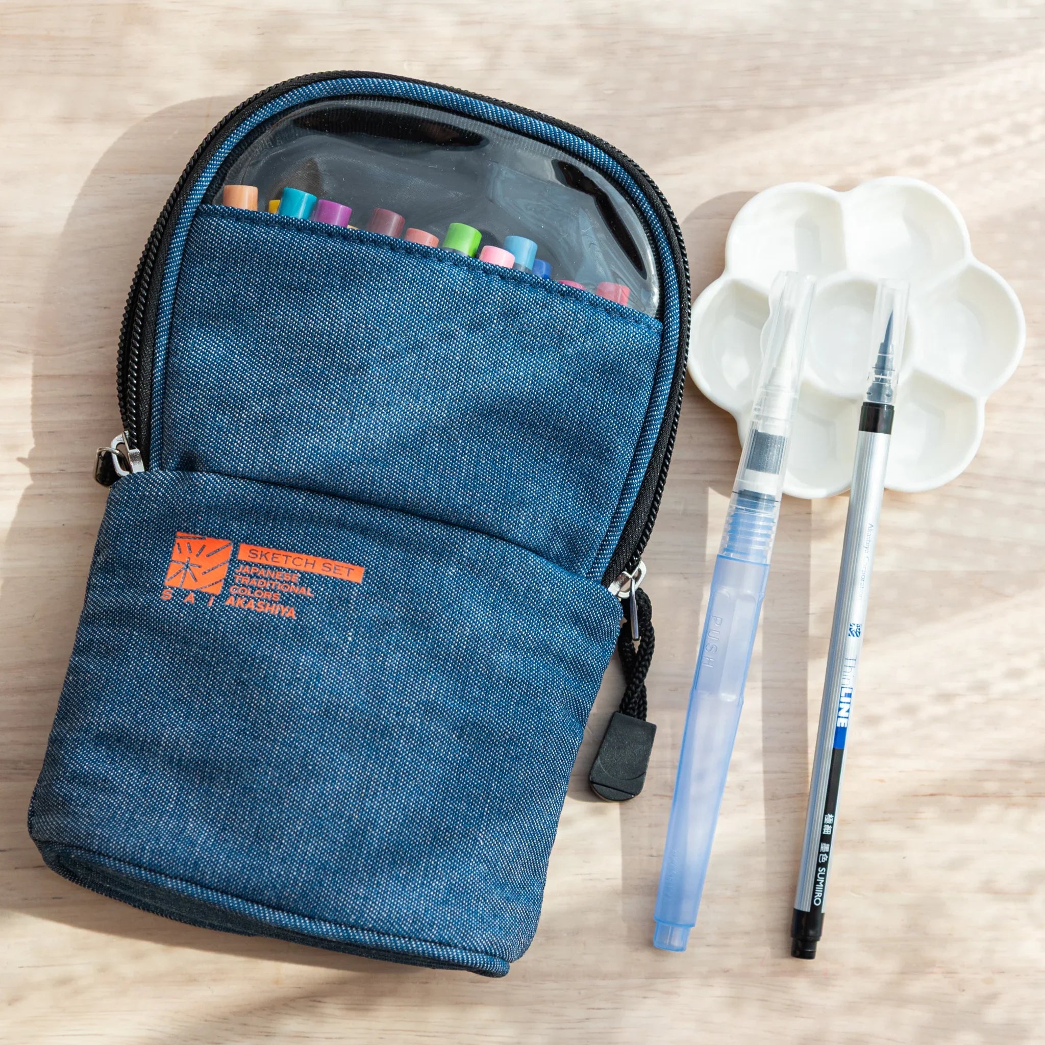 Japanese Akashiya Sai watercolor brush pen sketch set with denim carrying case displayed on neutral background