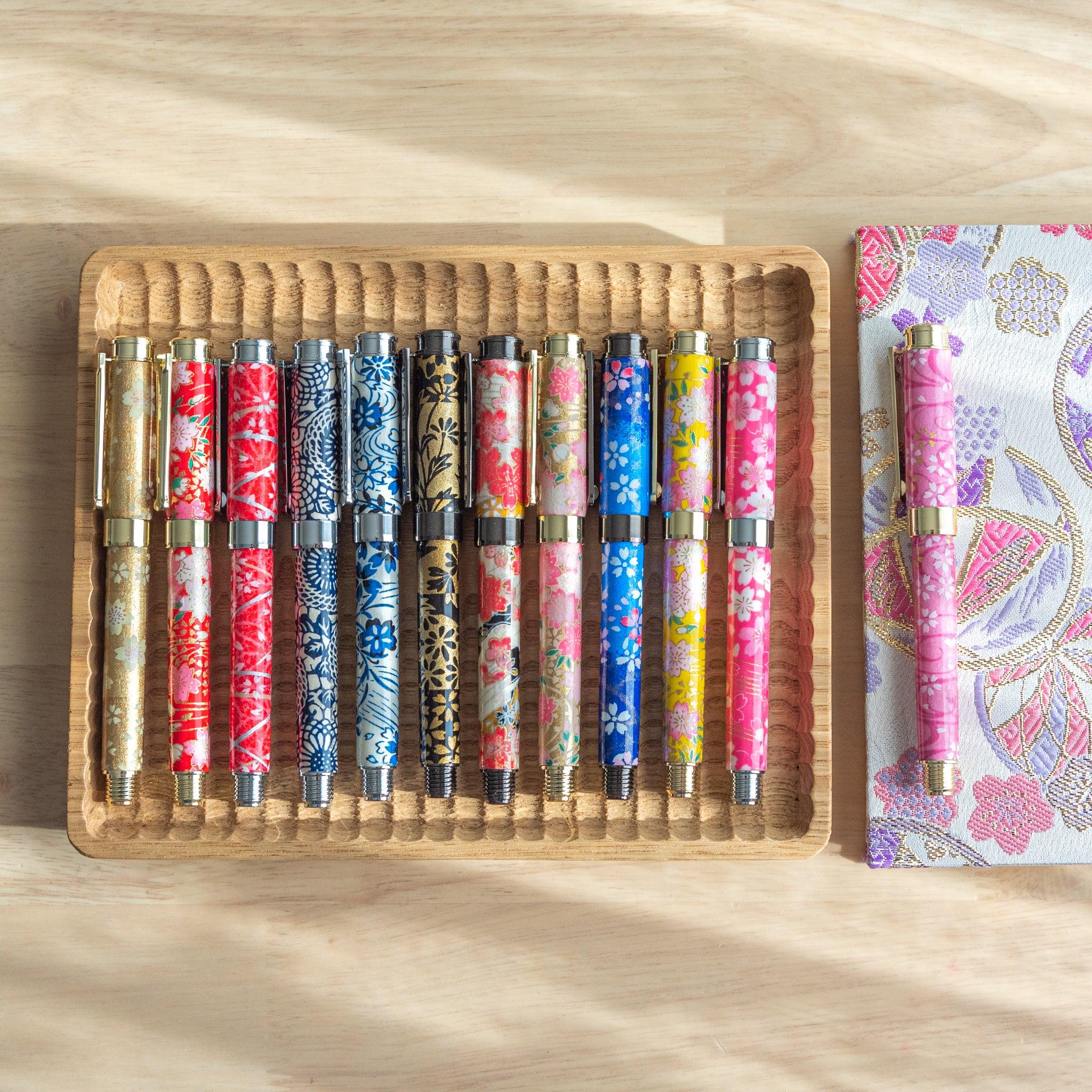 Akebono Cherry Mino Washi fountain pen detail highlighting botanical red cherry pattern with gold trim with nib