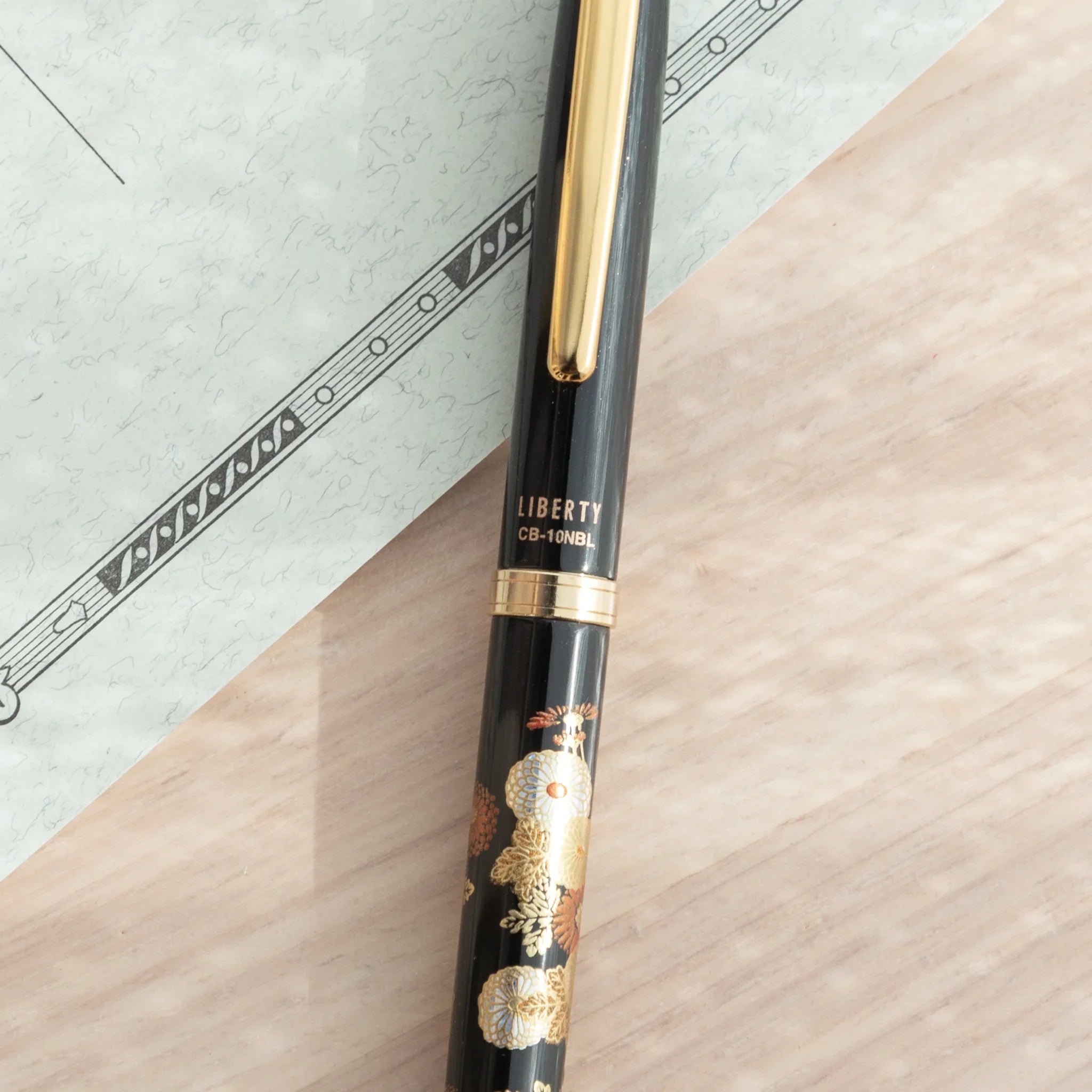 Traditional Yamanaka lacquered ballpoint pen depicts seasonal autumn botanical garden composition for writing