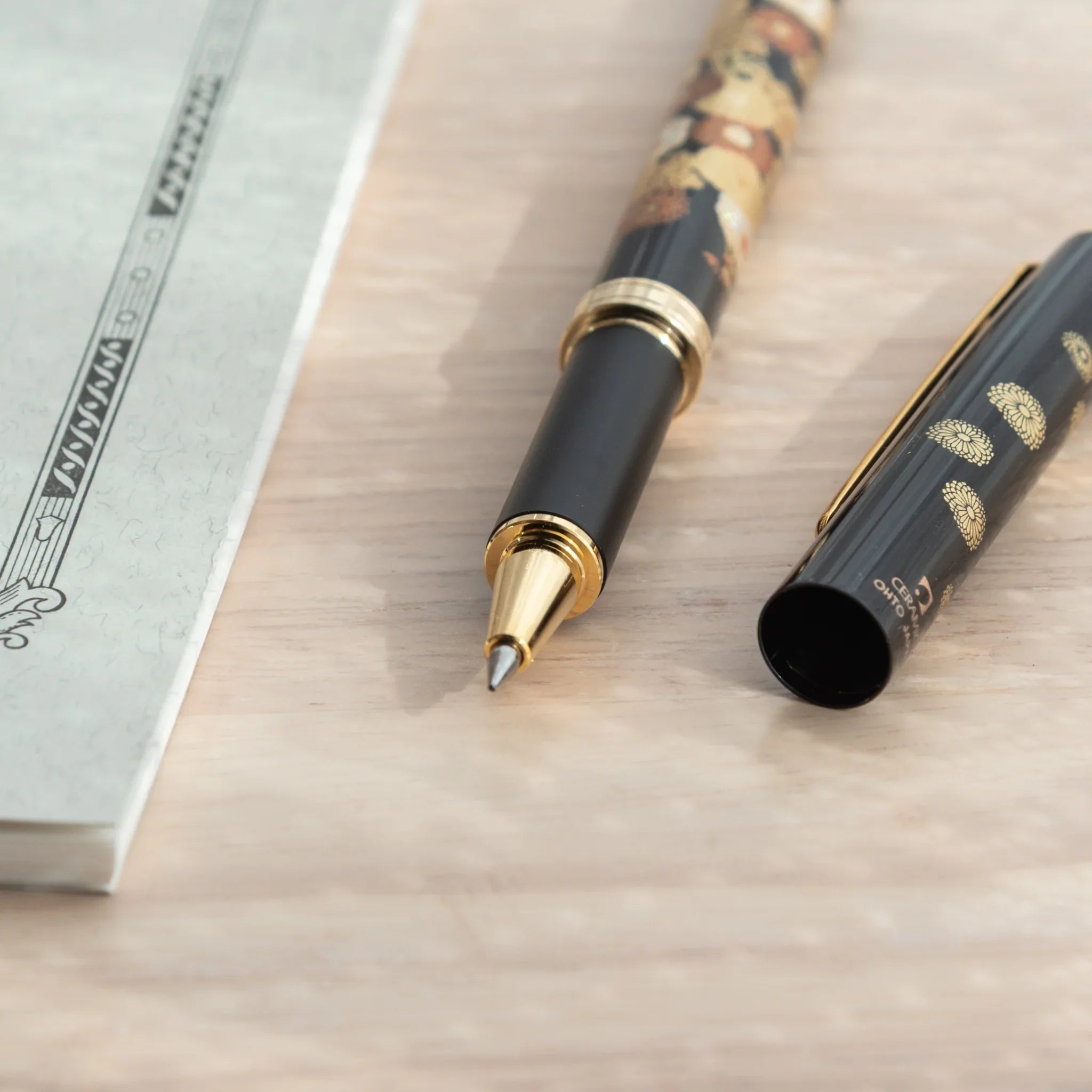 Golden Yamanaka ballpoint pen features detailed fall flowers and maple leaves lacquer painting for writing