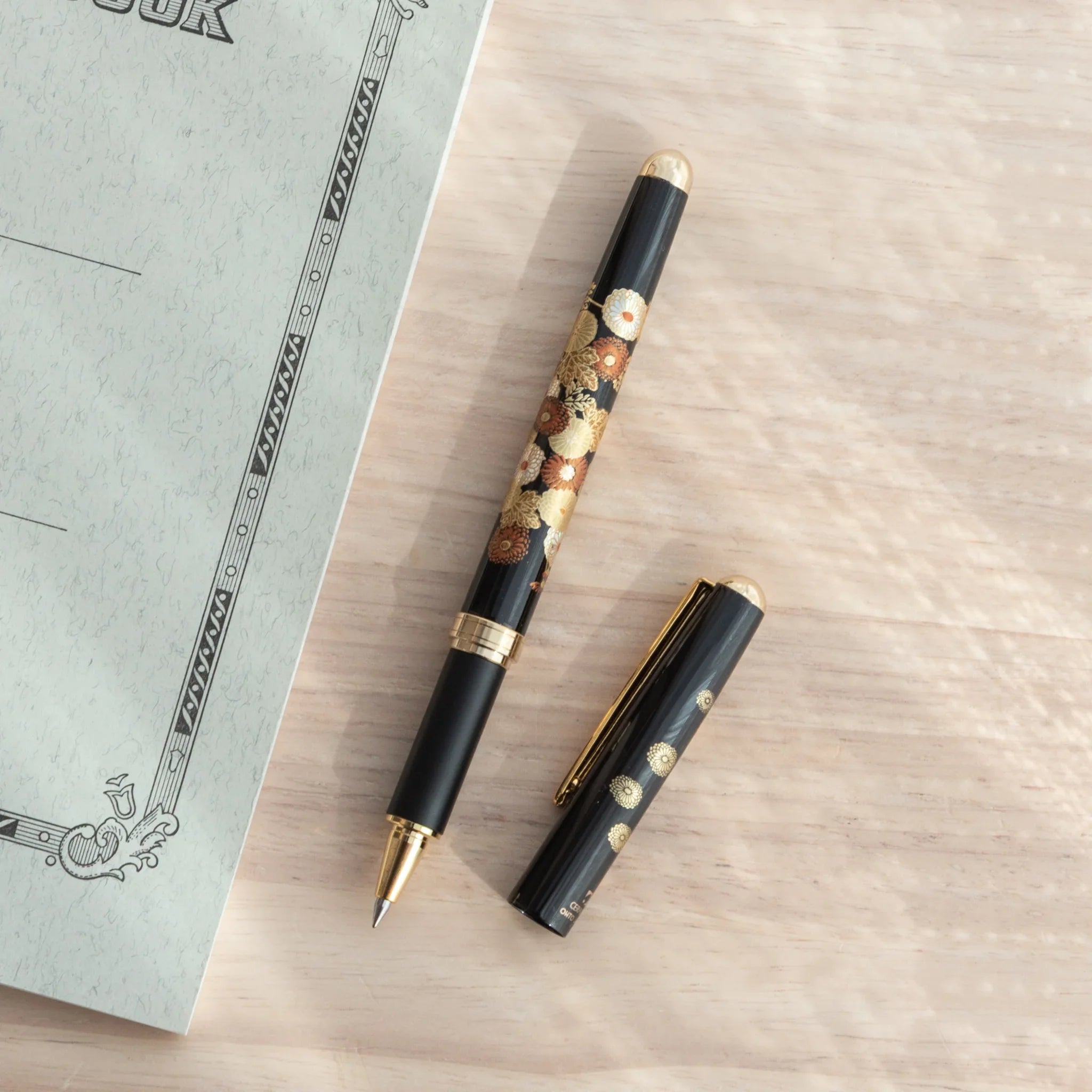 Yamanaka made ballpoint pen displays autumn botanical artwork with metallic gold accents made, Japan lacquer