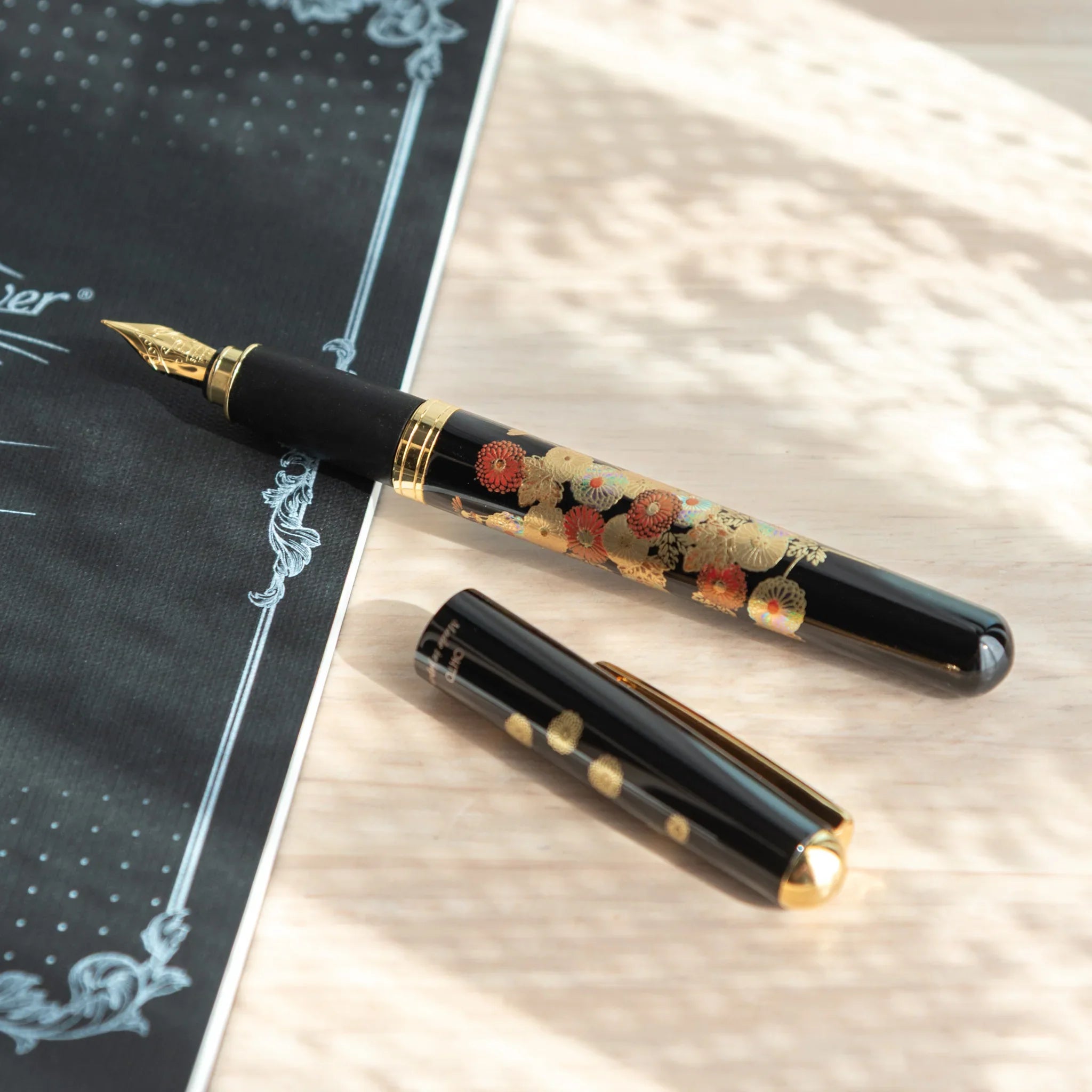 Autumn Blossoms Yamanaka fountain pen displays hand-painted lacquer fall foliage and flower detail made