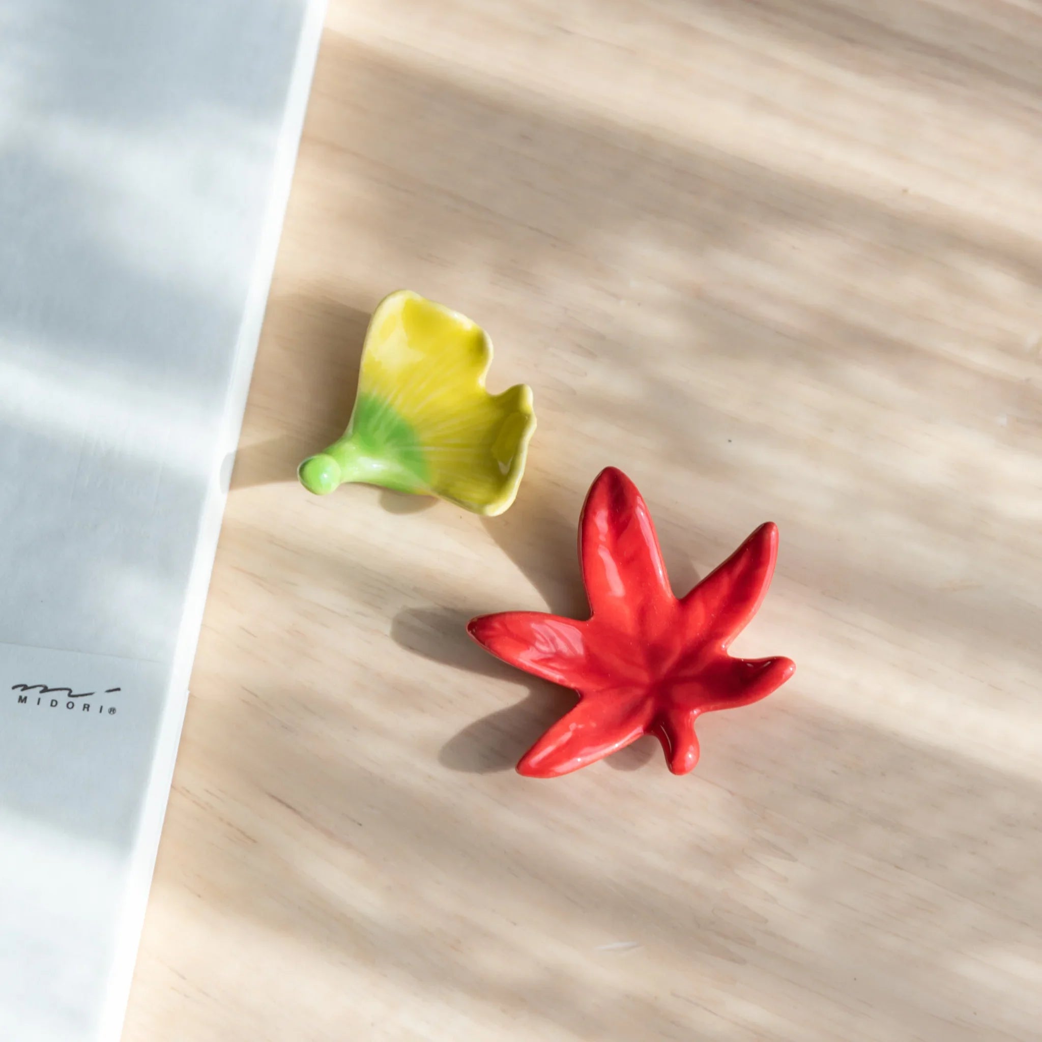 Autumn leaf handcrafted pen rest in yellow and green maple leaf with red accents showing fall seasonal color palette