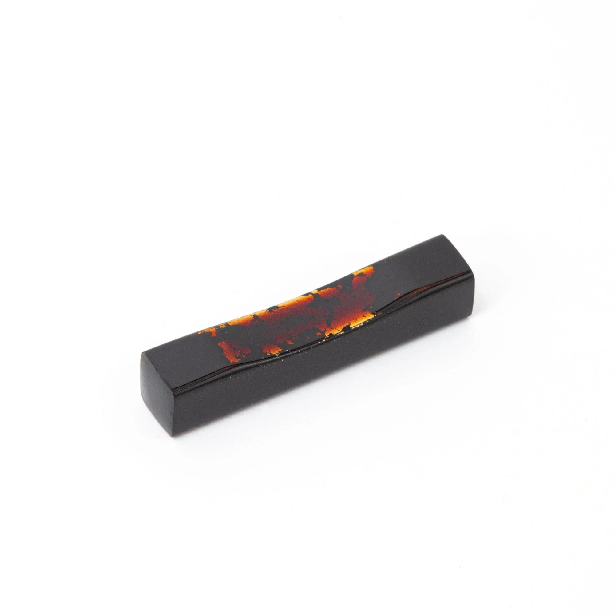 Echizen lacquered sakura wood pen rest features glossy black finish and gold fleck, keeping pens secure during work