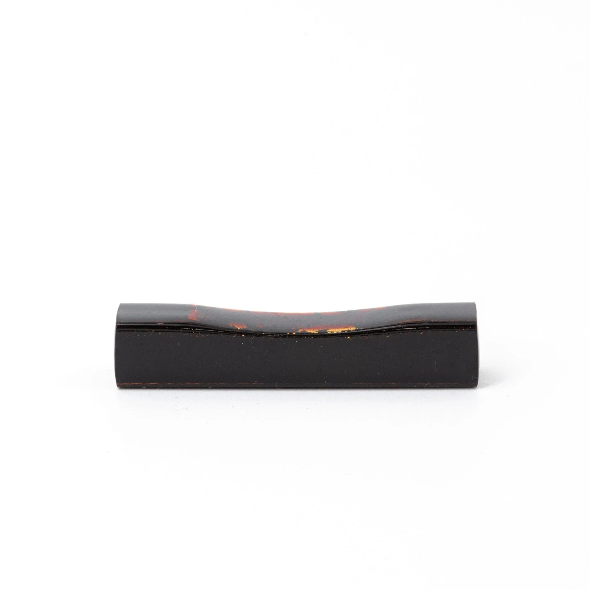 Luxury Echizen lacquer sakura wood pen rest features deep black glaze with precious gold fleck, keeping pens secure during