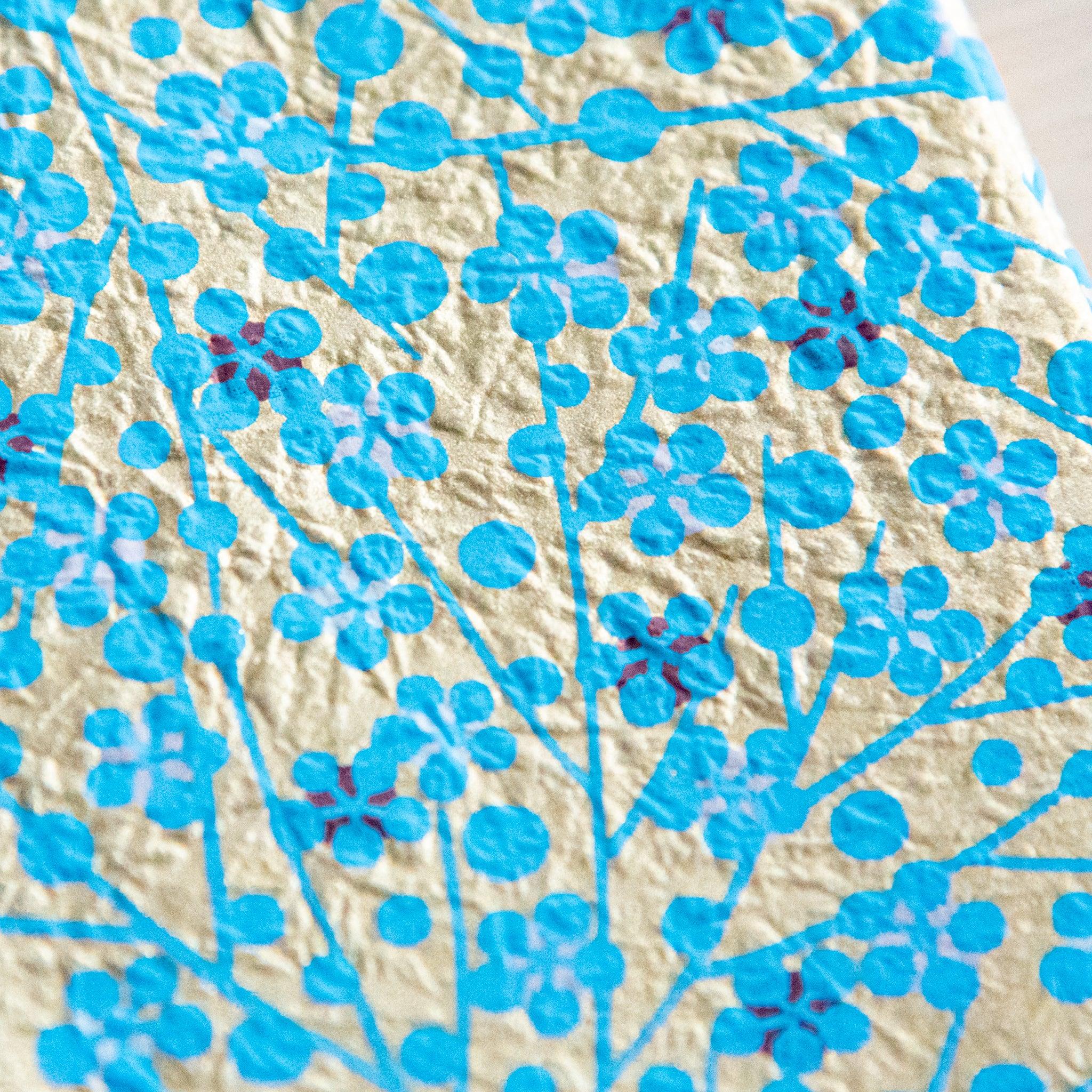 Blue flower washi paper book cover wrapped around A6 size book showing practical protective application