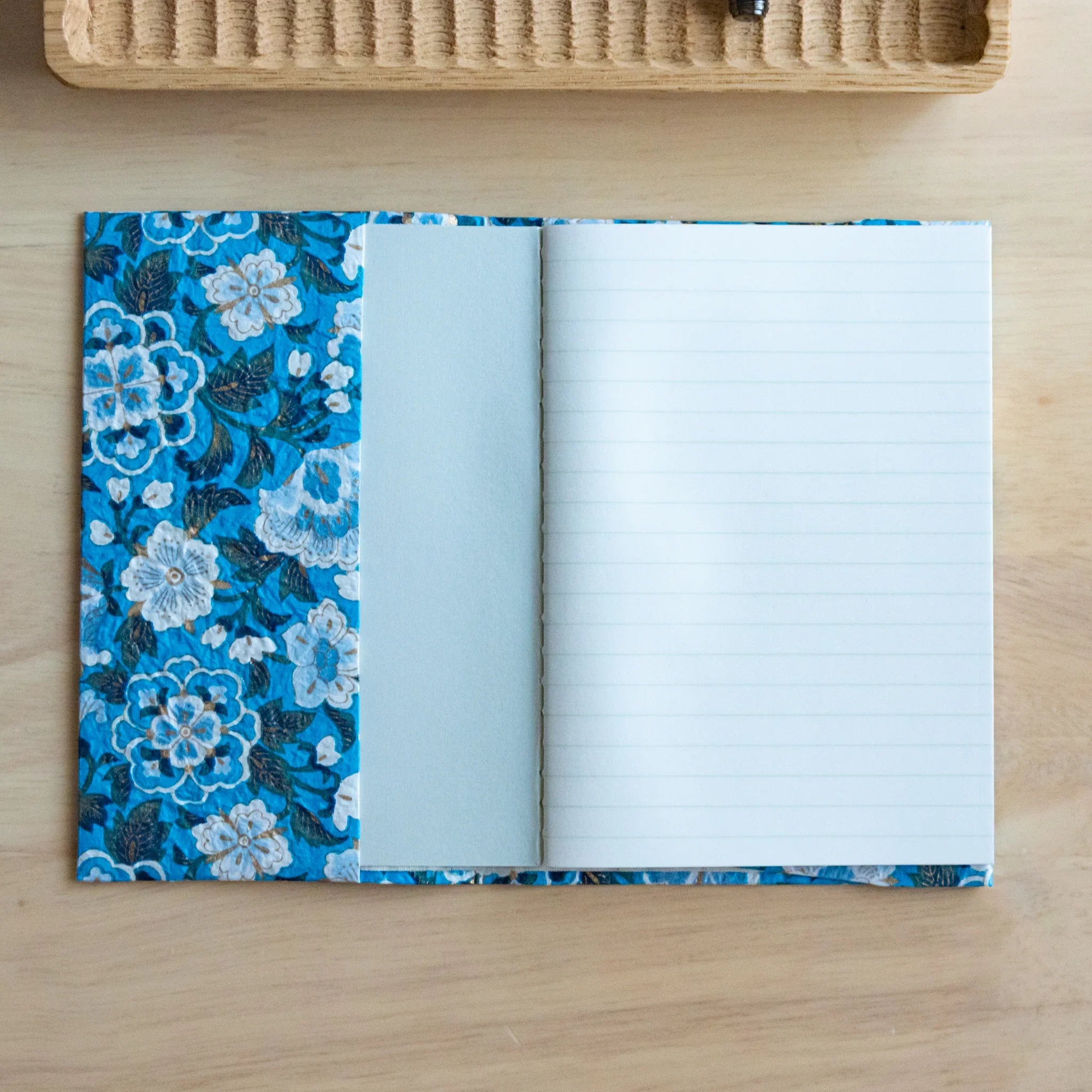 Blue garden hand-dyed yuzen washi book cover A6, angled side profile emphasizing dimensional embroidered flowers