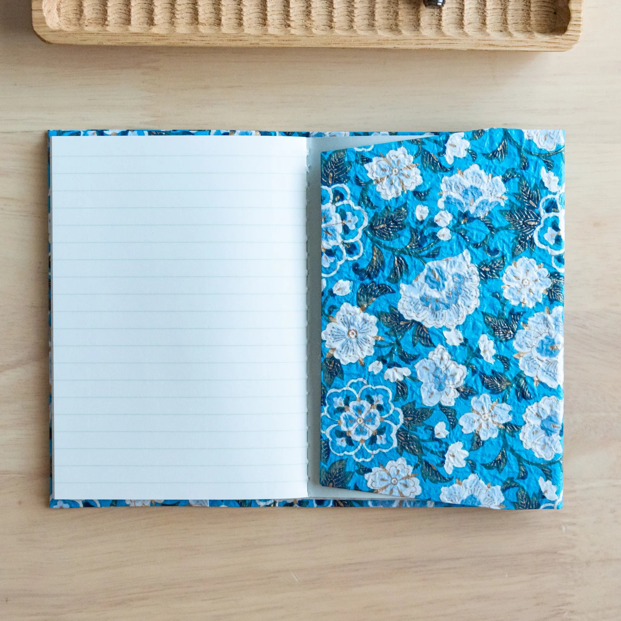 Blue garden hand-dyed yuzen washi book cover A6, tilted perspective showing translucent washi paper with dye art
