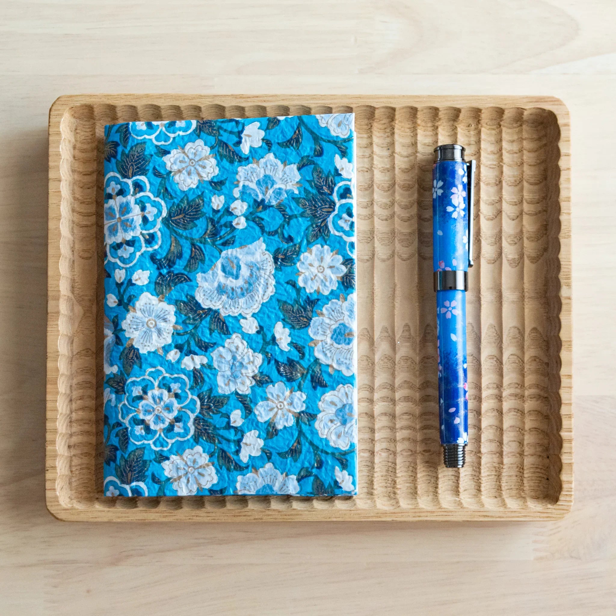 Blue garden hand-dyed yuzen washi book cover A6, angled view from side highlighting surface detail of pattern hue