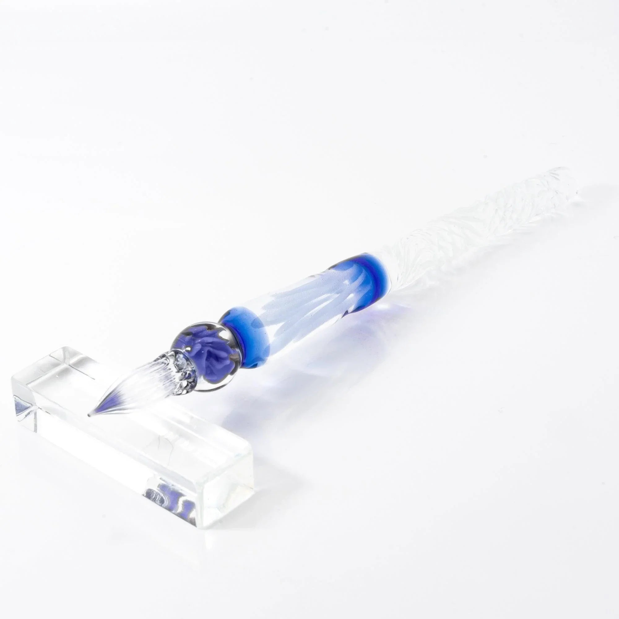 hand-made blue rose glass pen displayed to highlight intricate metal work and deep blue glass material shine
