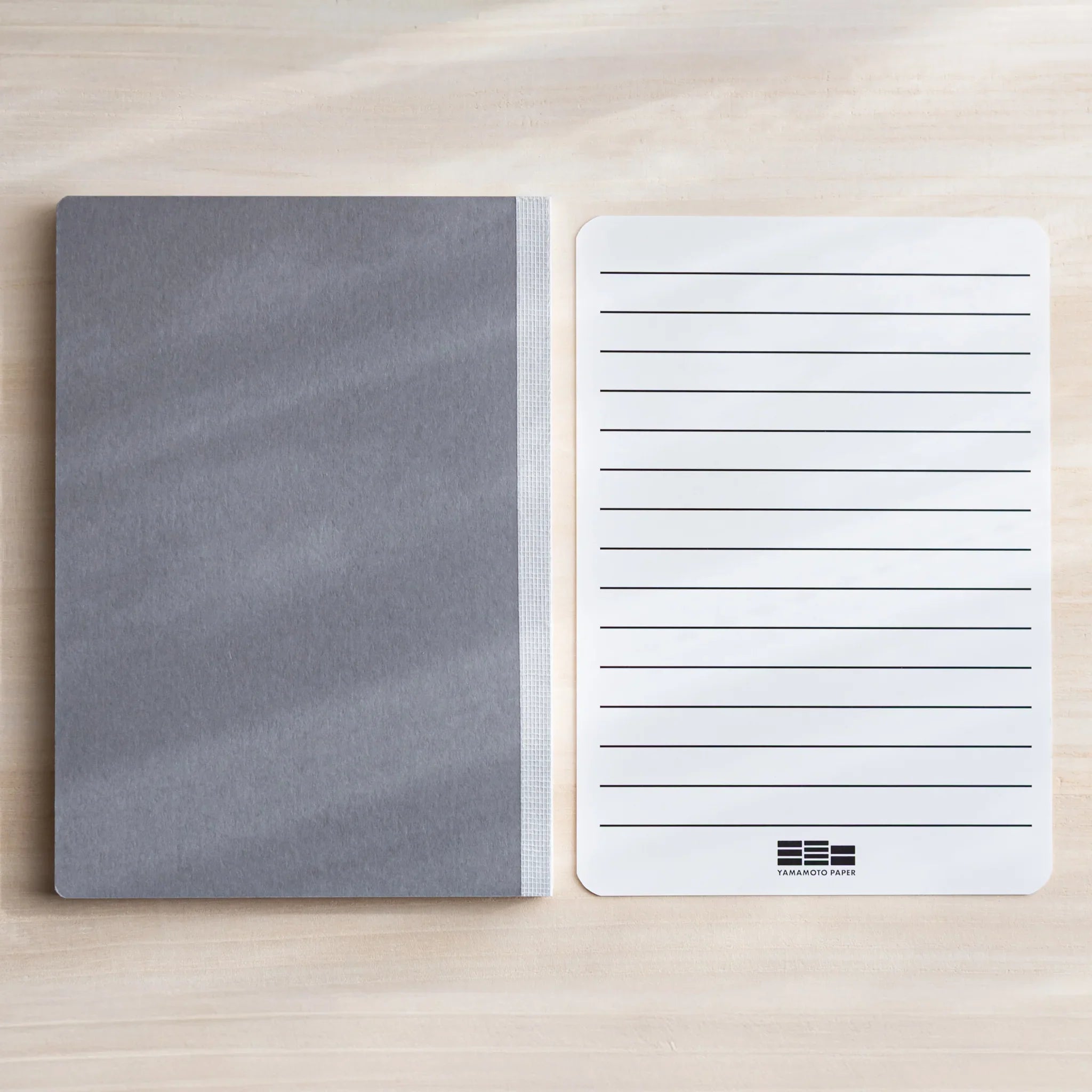 Lifestyle shot of CANOPUS notebook being used for writing or sketching showing product quality and design details