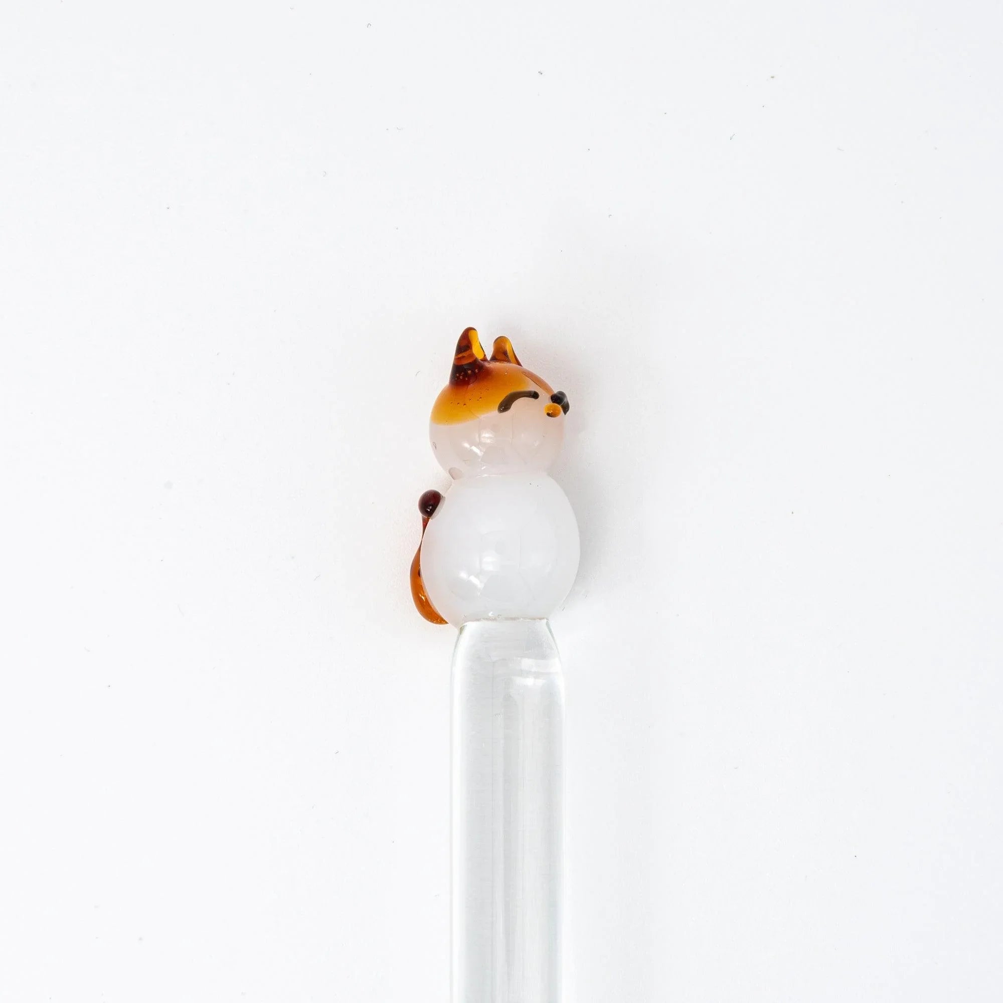 Angled display of Cat Perch glass dip pen in active writing use showing pen control and artistic design with holder