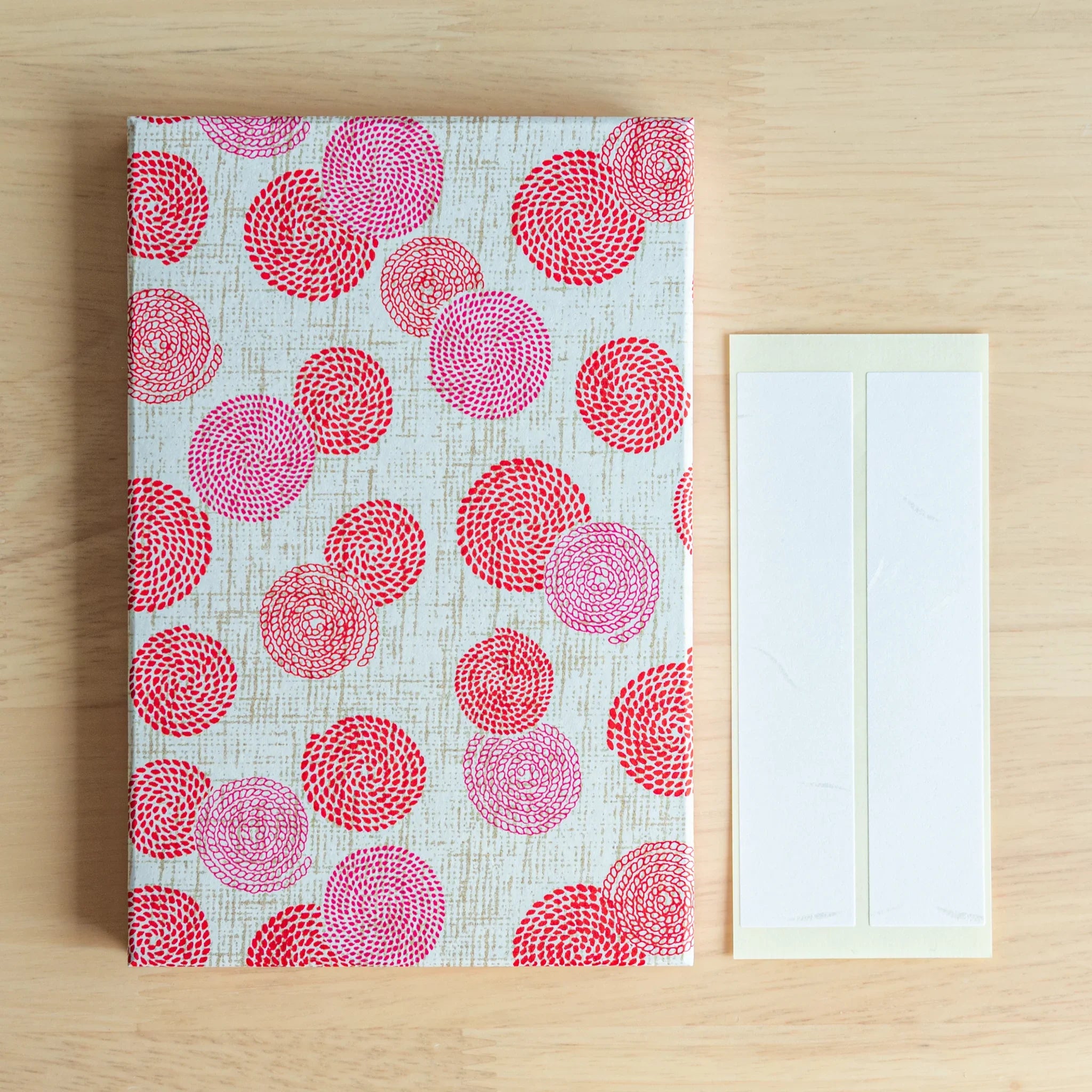 Side profile view of Circle of Blossoms goshuincho showing spine binding and cover depth showing floral washi goshuincho c