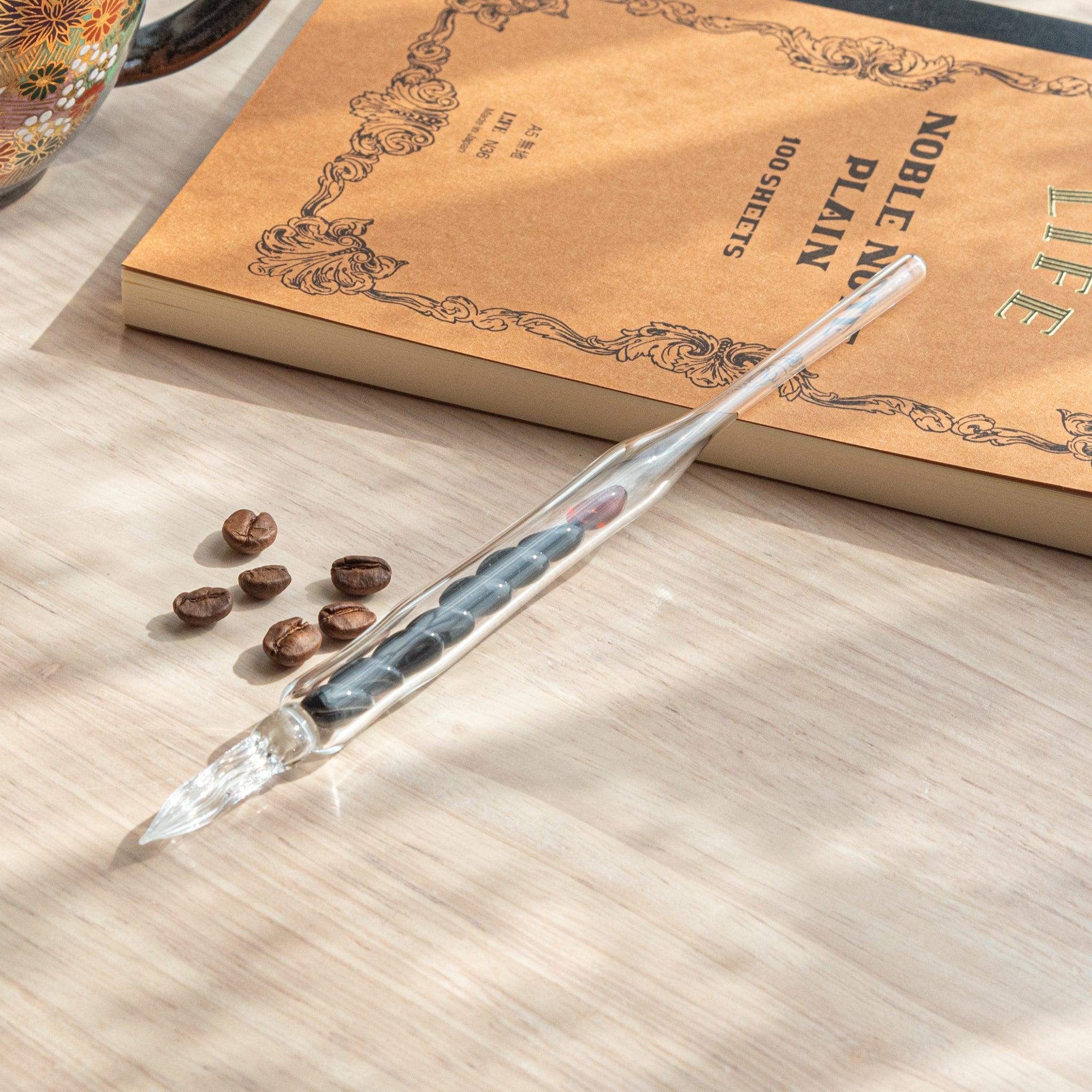 City Roast Coffee Beans Glass Dip Pen detail with tan glass barrel etched with coffee bean pattern and black ink cartridge