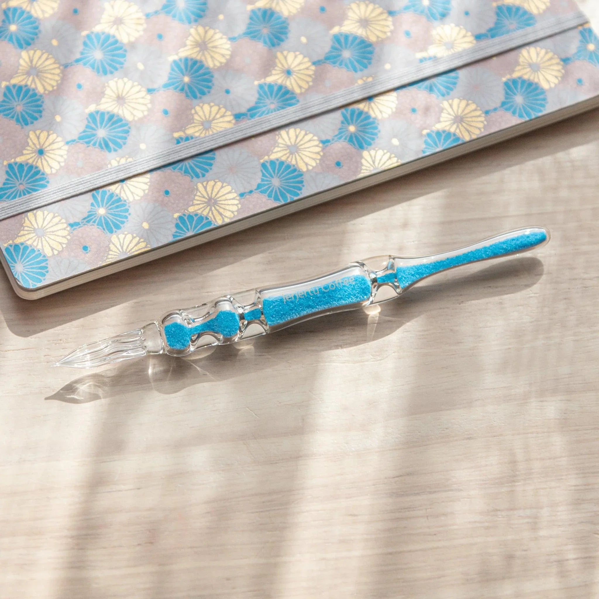 Cote d'Azur Hourglass Glass Dip Pen angled view showing three distinct segments with blue ombre effect in glass barrel