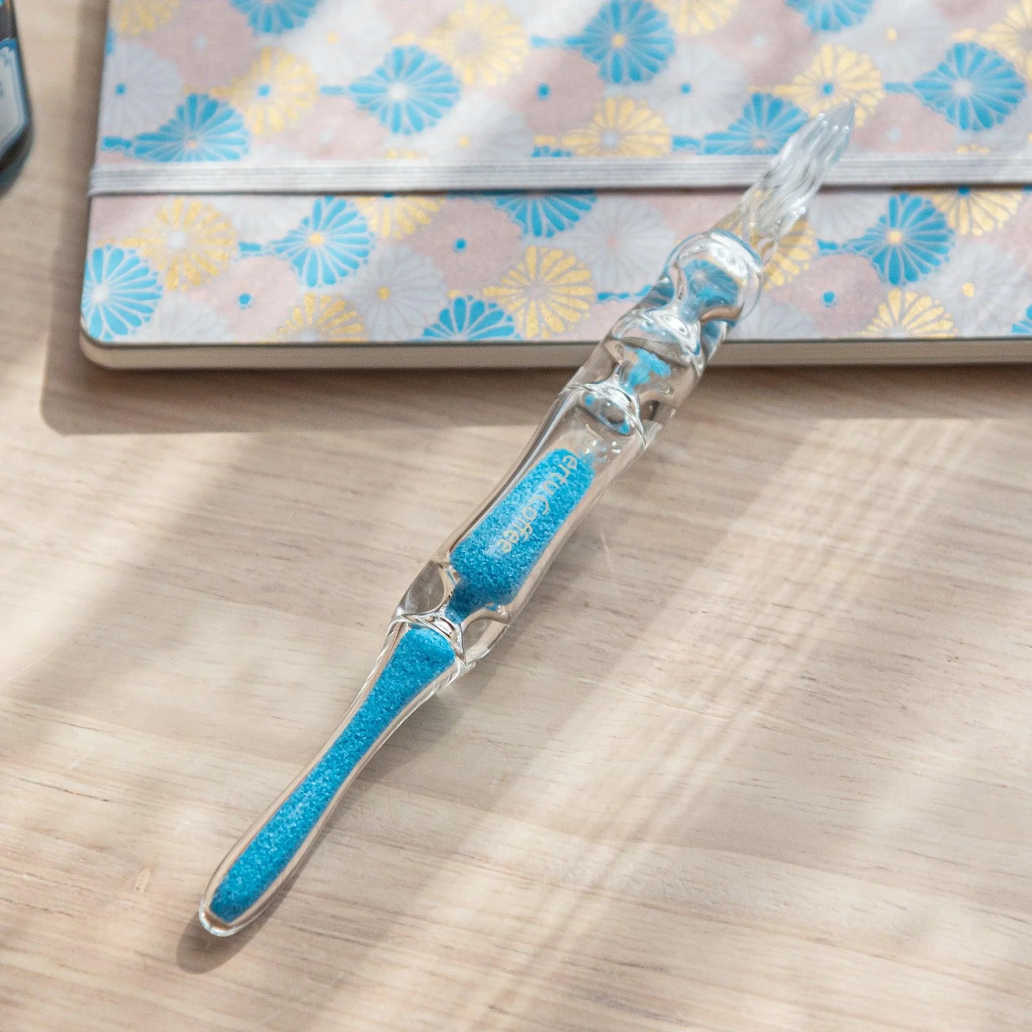 Cote d'Azur Hourglass Glass Dip Pen with rich turquoise chambers arranged in curved hourglass form within glass barrel
