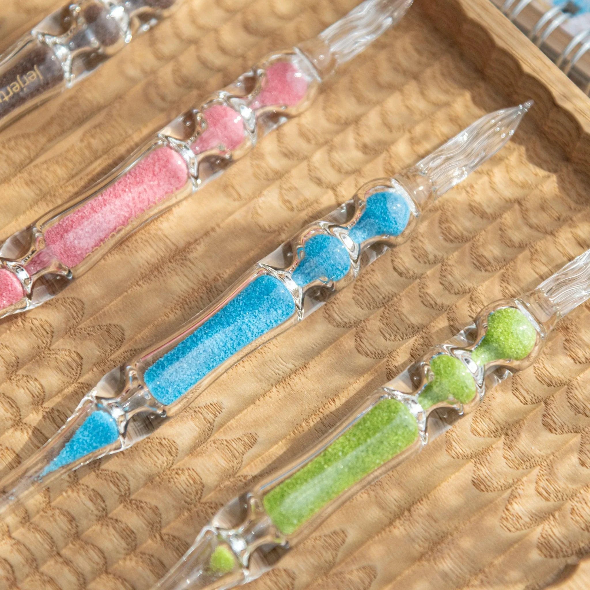 Cote d'Azur Hourglass Glass Dip Pen with distinct blue pigmented bulbs in clear glass barrel and visible metal nib