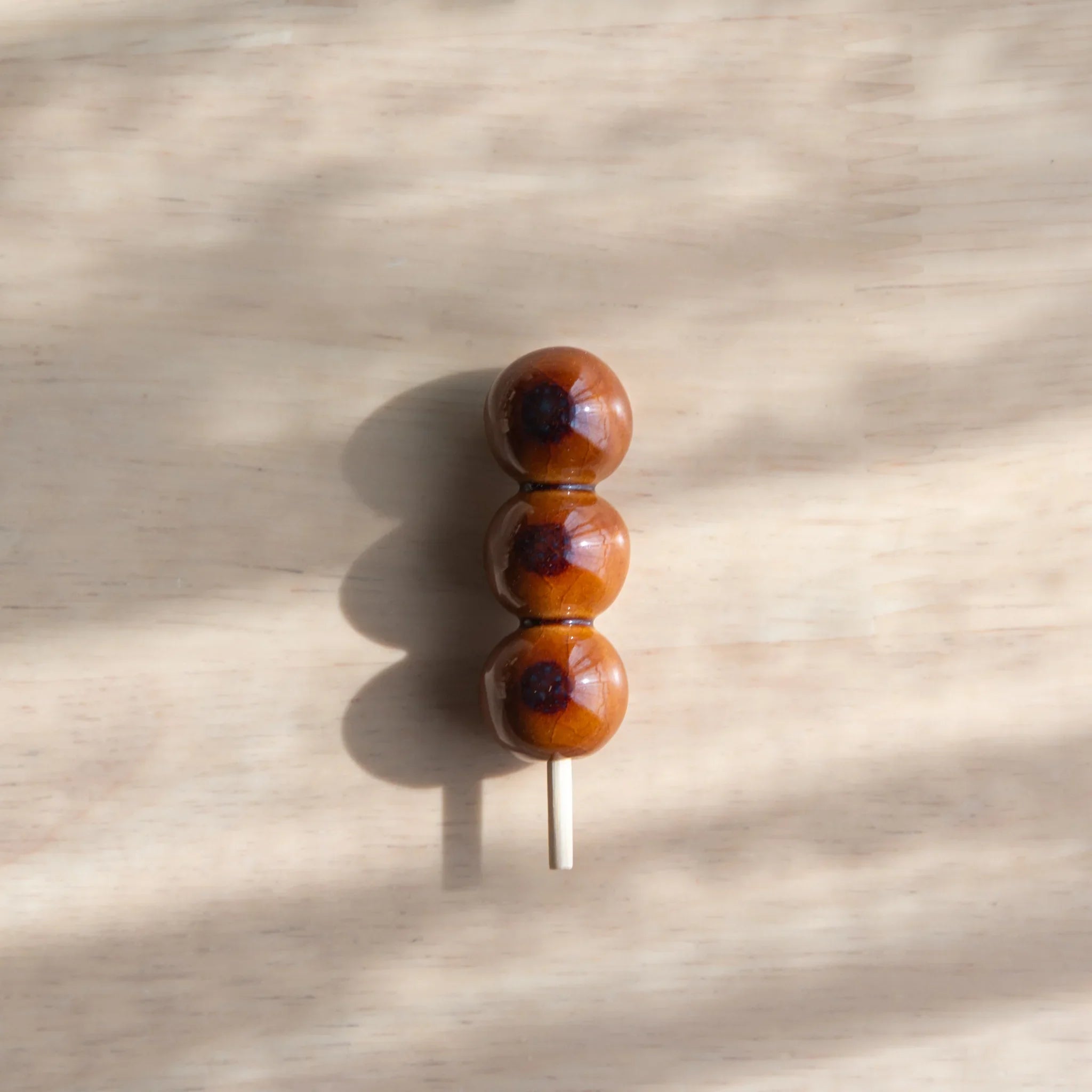 Horizontal display of six dango handcrafted pen rests showing varied multicolor bead combination patterns together