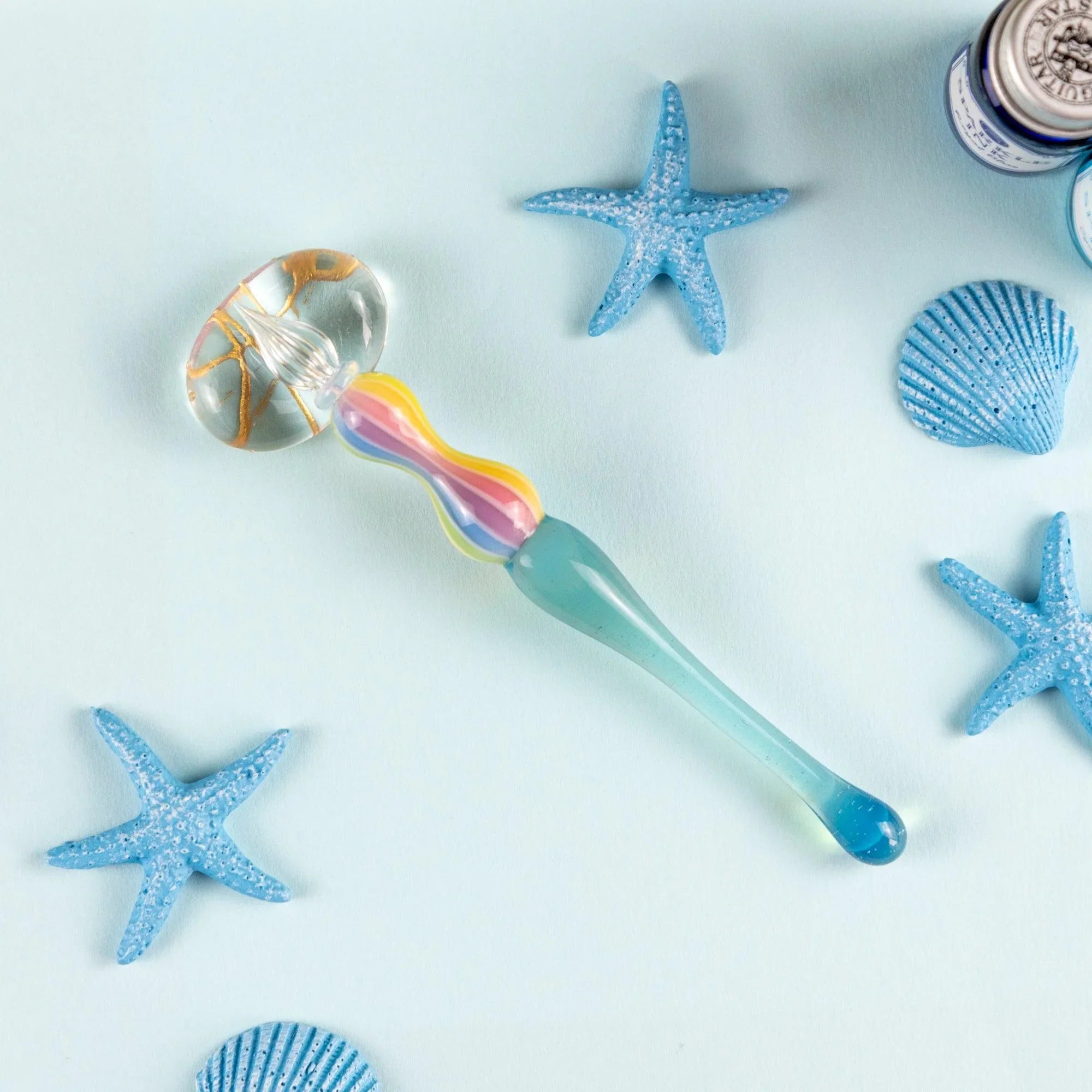 Overhead view of Dreamy Rainbow Marin glass balloon pen on white background for calligraphy and ink illustration work