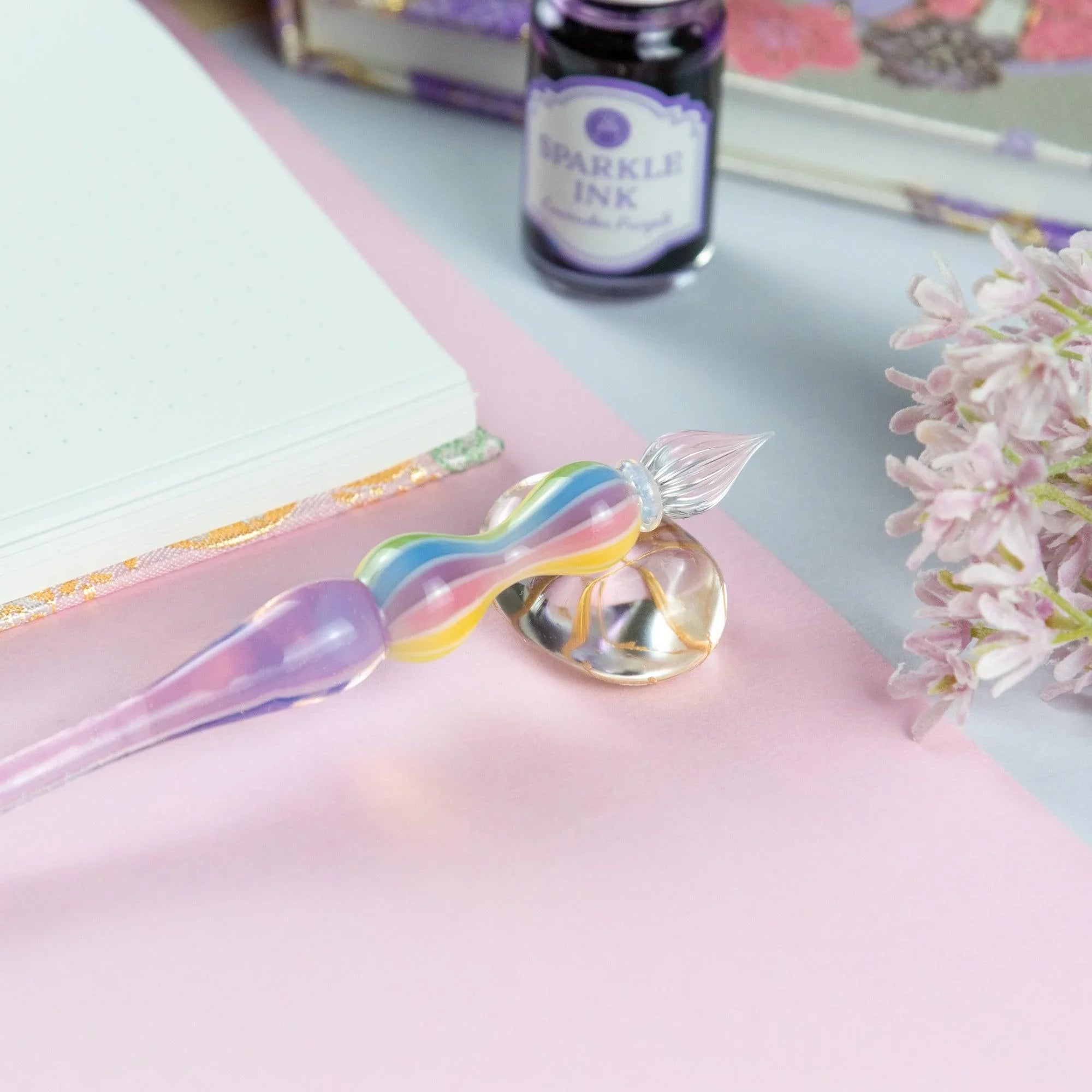 Close-up of Rose variant glass pen showing color gradation and translucent glass quality and finish showing product qualit