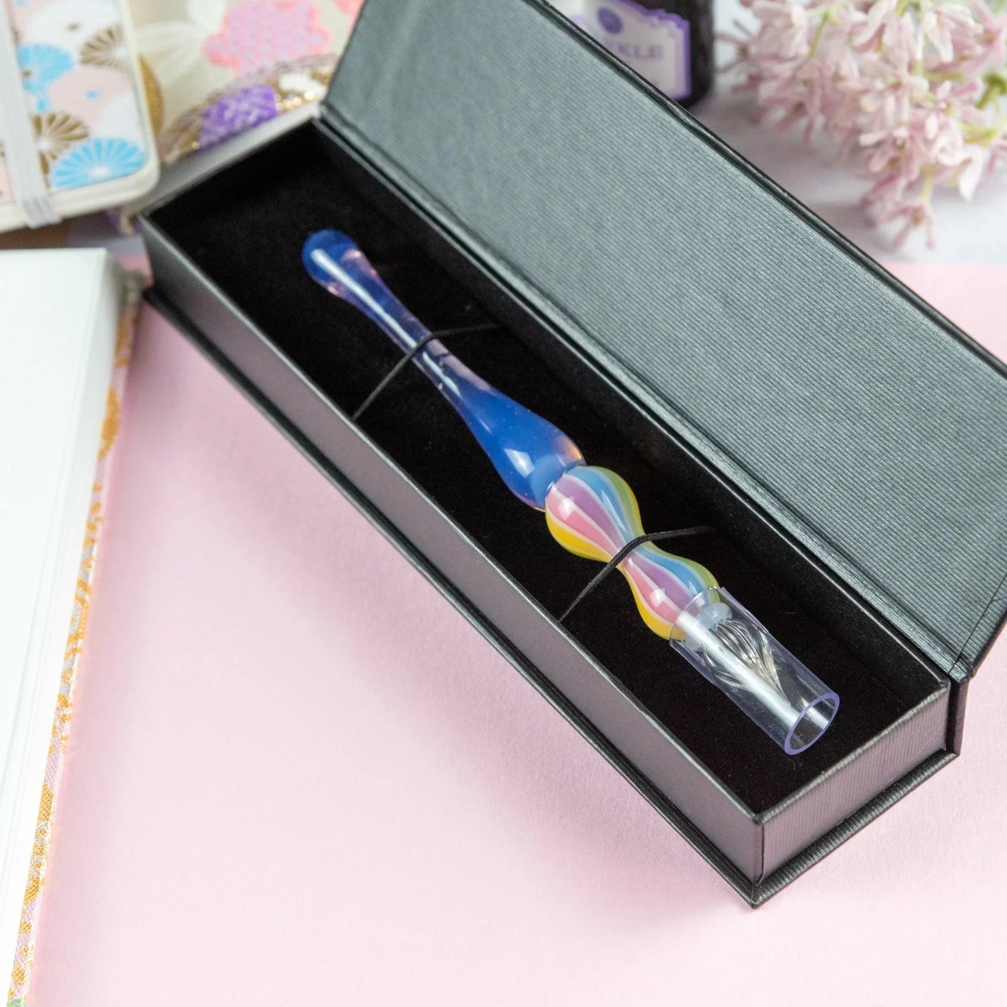 Rose variant glass dip pen in creative workspace setting with coordinating writing materials and setup