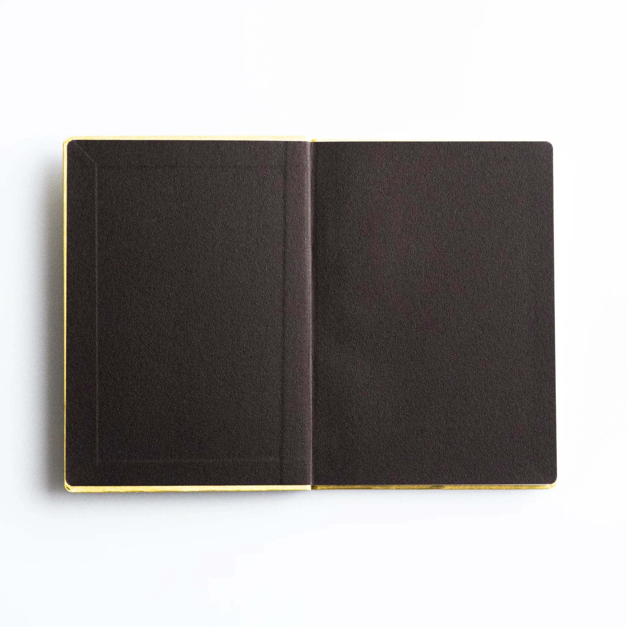 Dressco Bank Ledger Paper A6 notebook three-quarter angle view showing the cover face and sewn binding at spine
